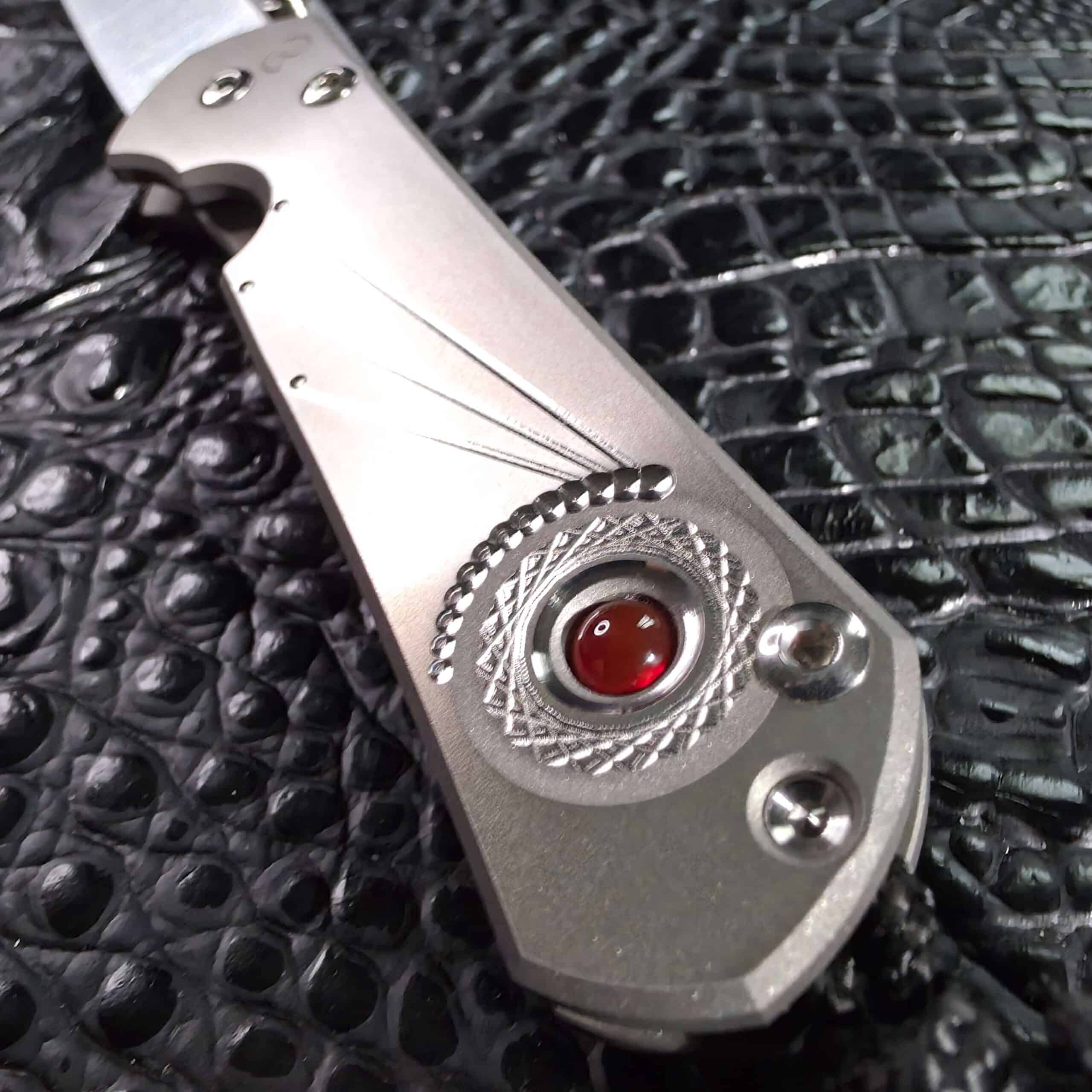 Sunburst Unique Graphic machining radiating from a carnelian cabochon on satin titanium