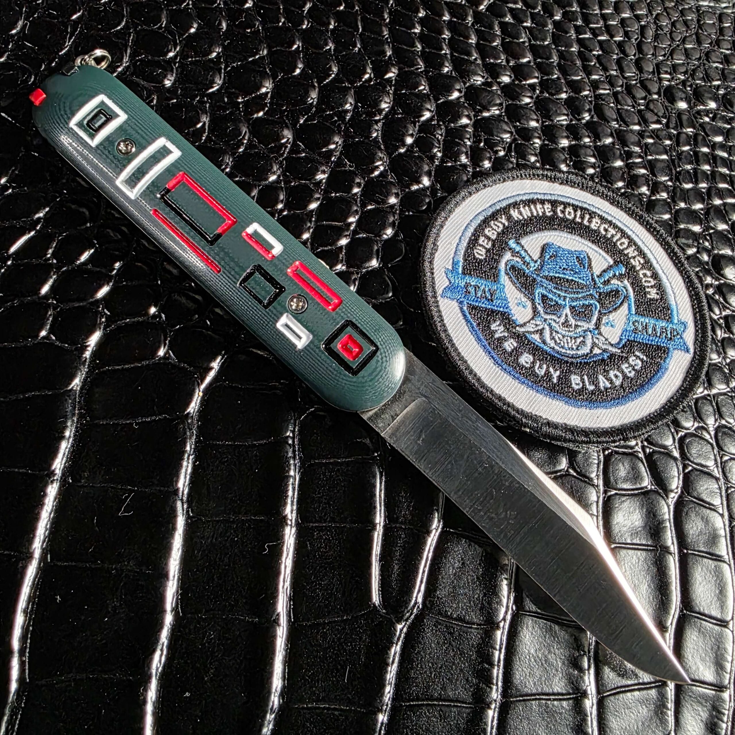 Chuck Gedraitis Switch Army Switchblade open with reverse green G-10 scale and satin Nitro-V blade