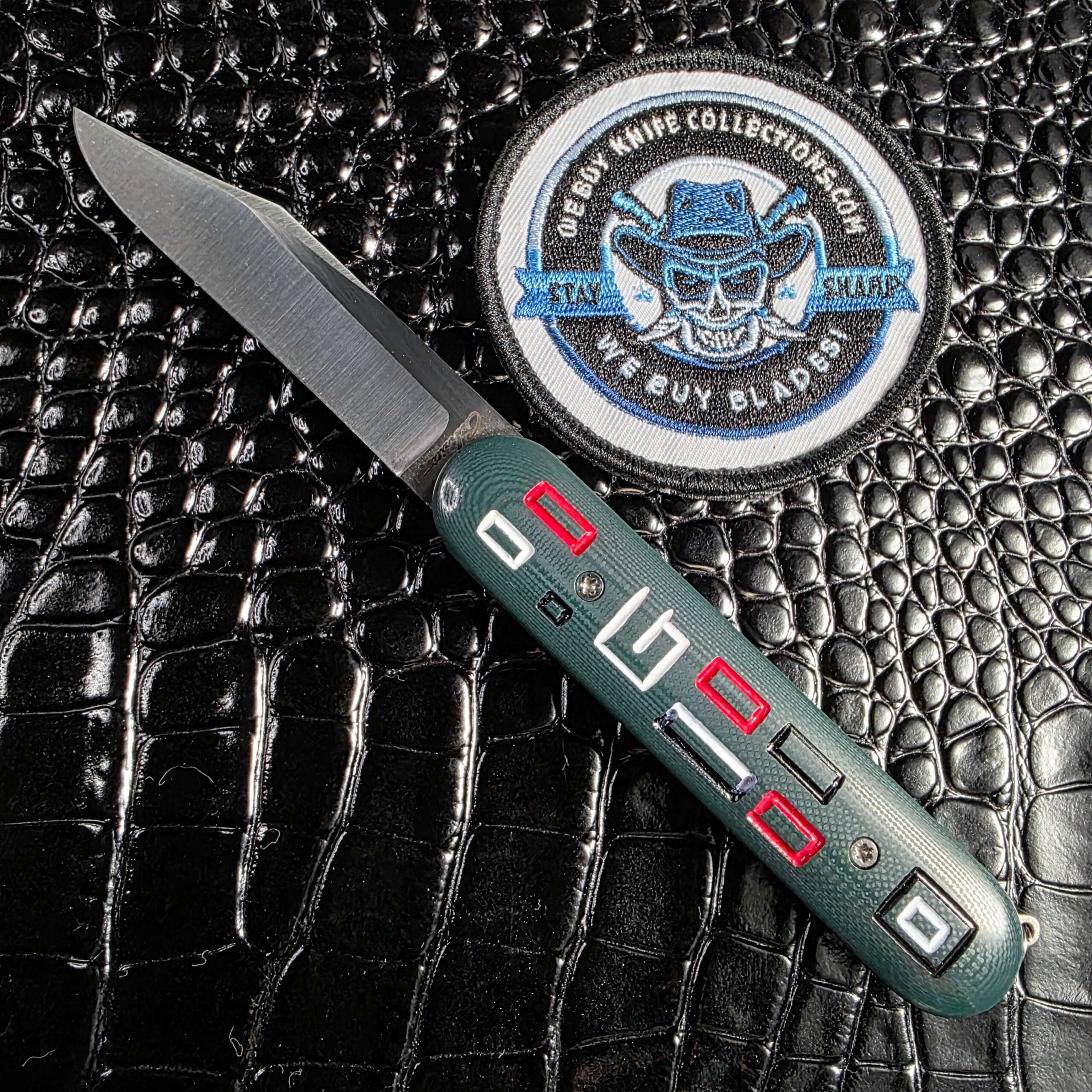 Chuck Gedraitis Switch Army Switchblade open show side with milled green G-10 mosaic and Nitro-V spear point blade