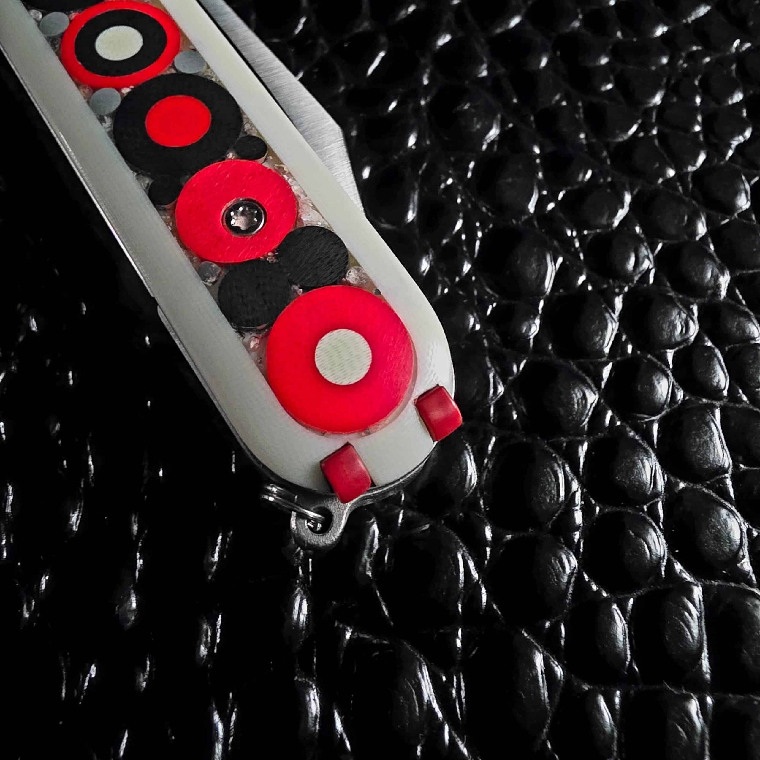 Angled view of the hand-laid mosaic micarta scale on the Chuck Gedraitis Switch Army Retro Edition