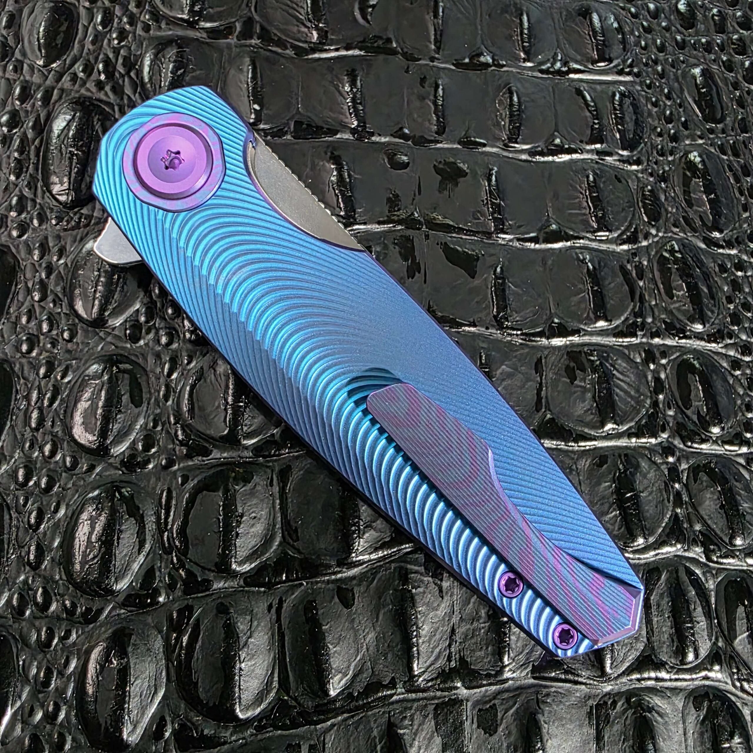 Closed clip side of the Holt Bladeworks Morpheus #1856 with the full anodized titanium pocket clip in view