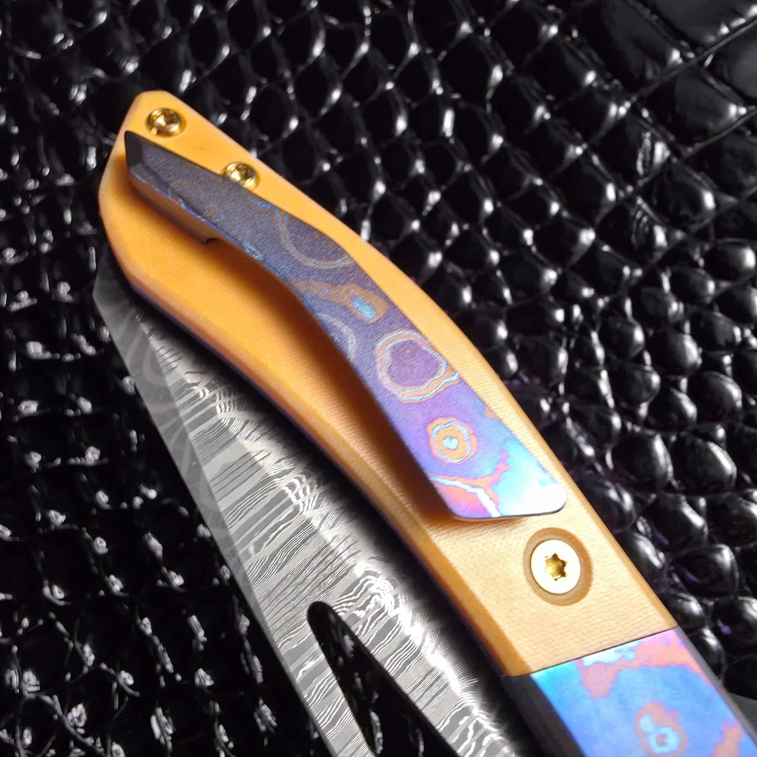 Radmascus pattern welded titanium pocket clip on a Keanison Bloodhound liner lock