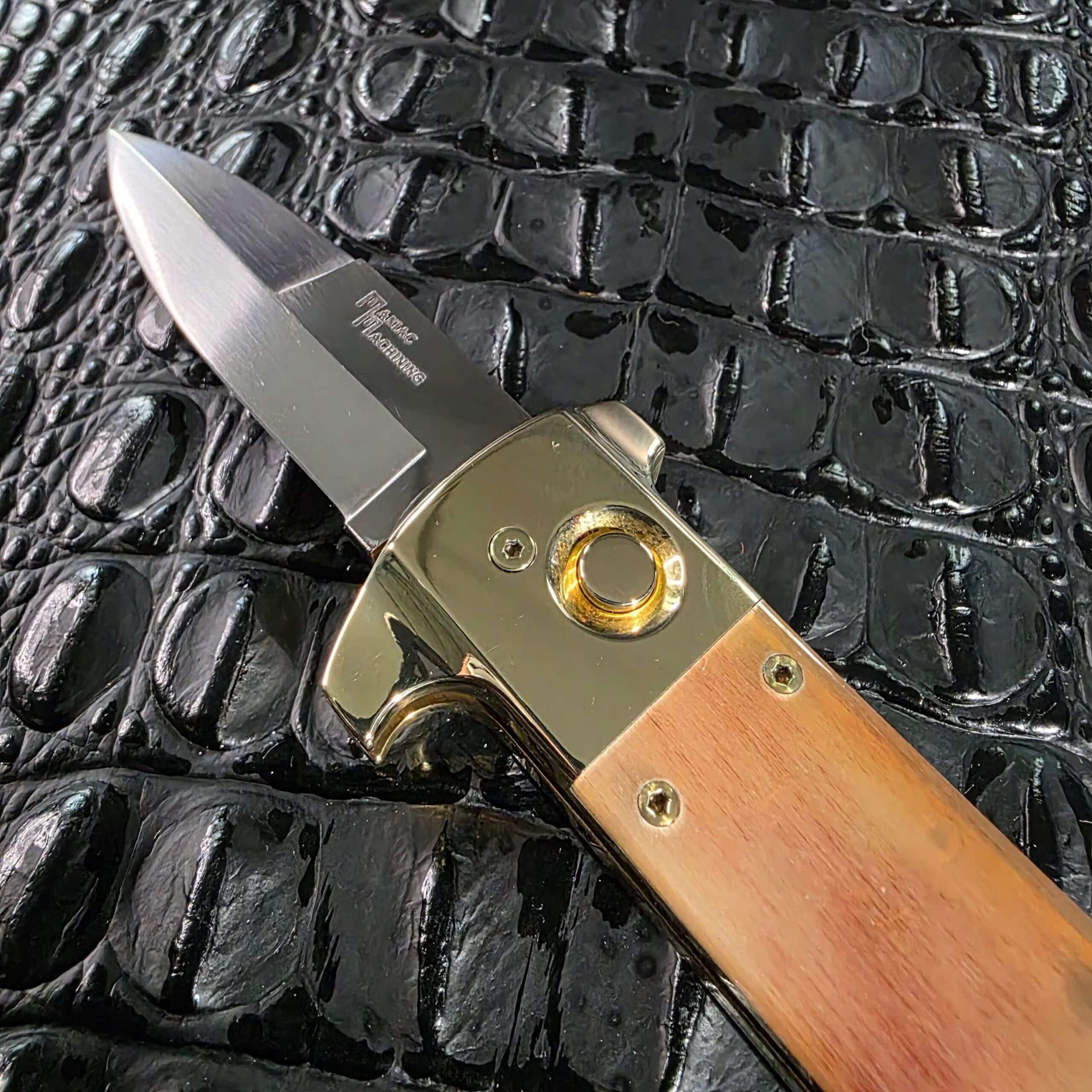 Blade, pivot, and brass button detail on the Maniac Machining Stinger Classic