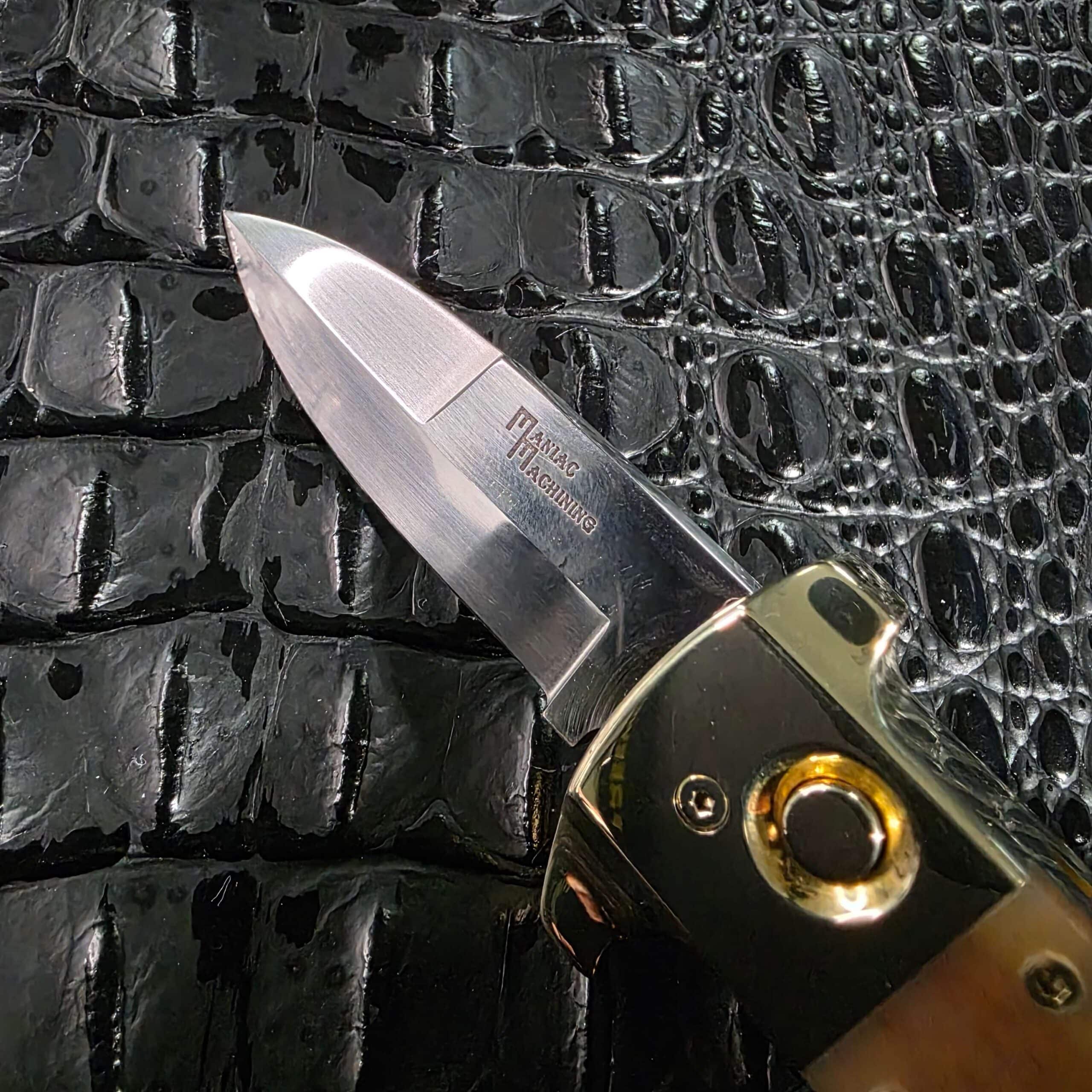 Hand-ground 440-C stainless blade with visible grind lines on the Maniac Machining Stinger Classic
