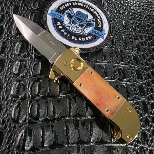 Maniac Machining Stinger Classic automatic knife open with brass frame and blonde yak horn scales