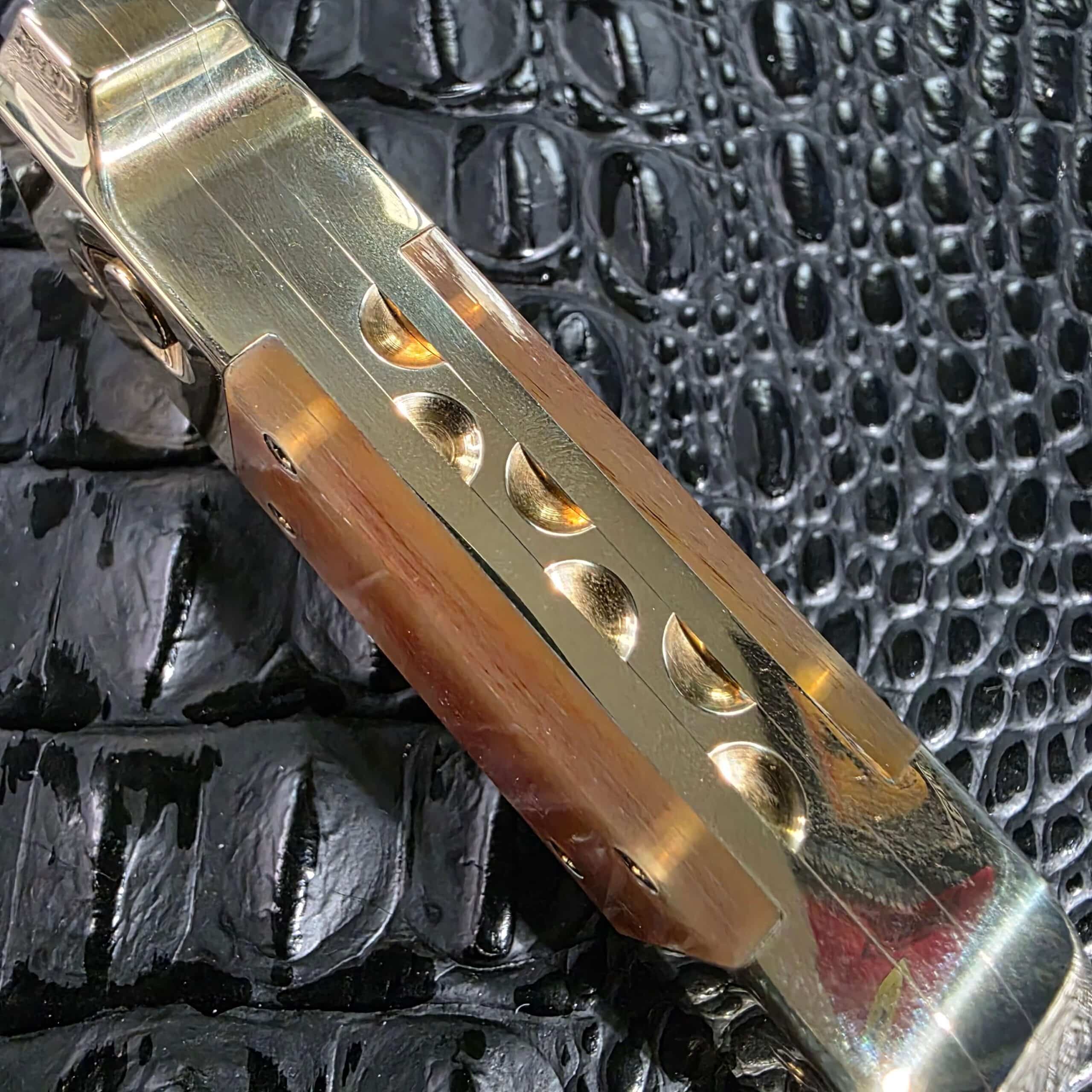Macro of the hand-milled scalloped spine work on the brass frame