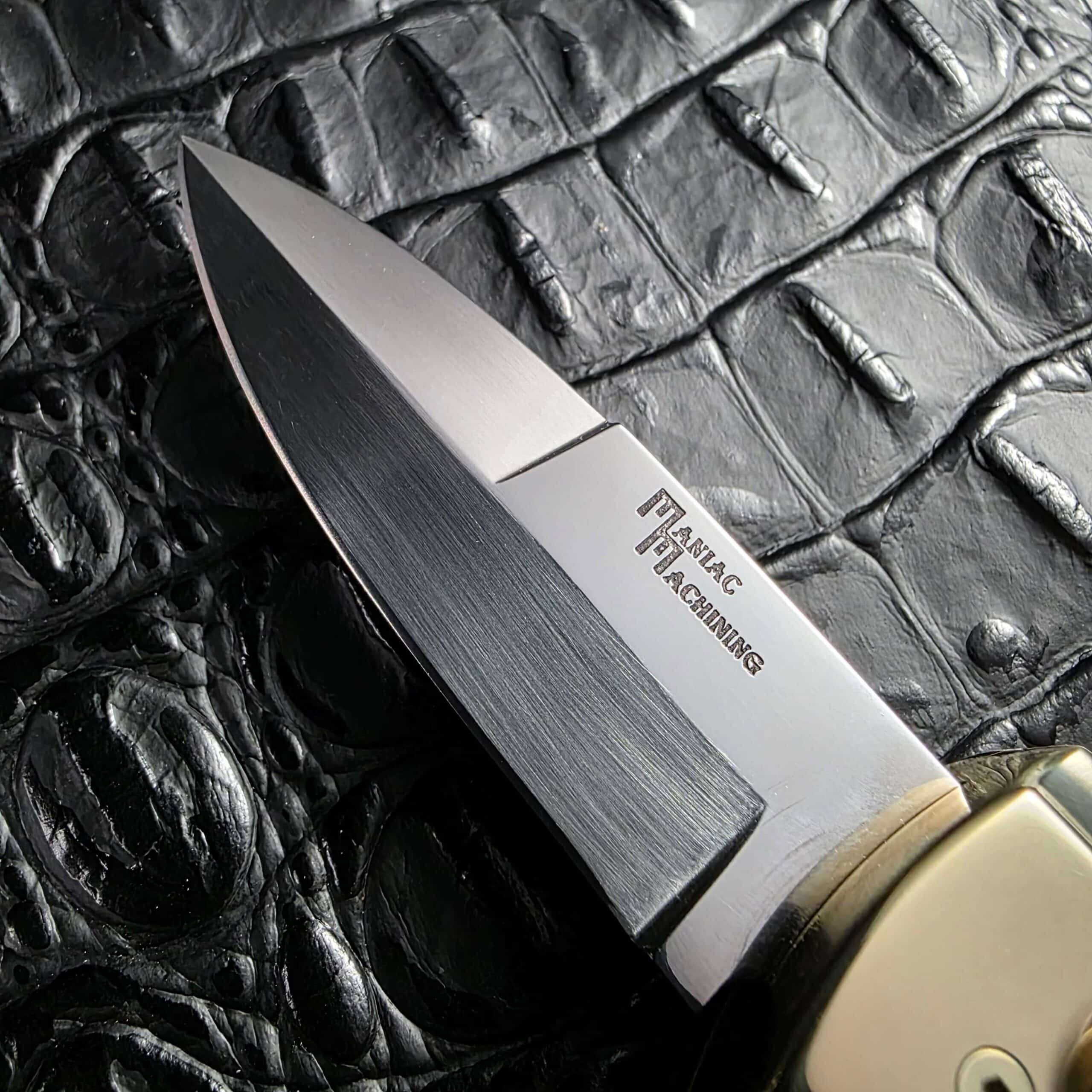 Grind lines and untouched factory edge on the Maniac Machining Stinger Custom blade