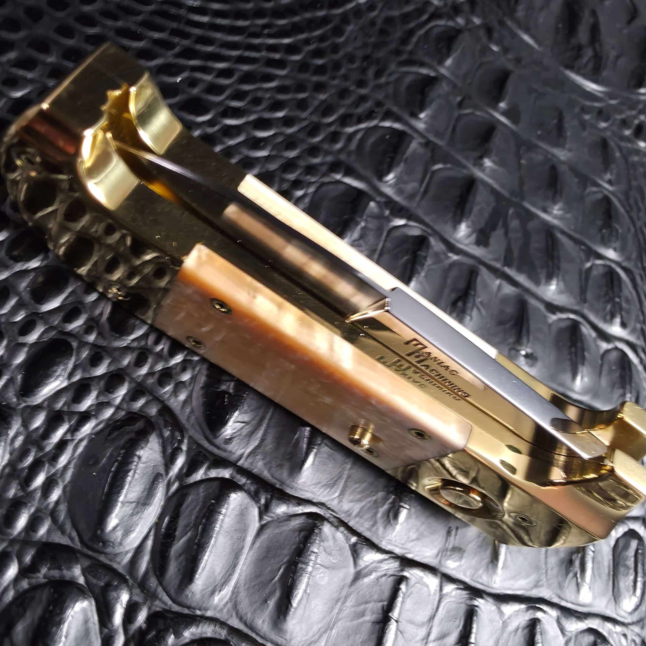 Maniac Machining maker's mark etched on the mirror polished blade