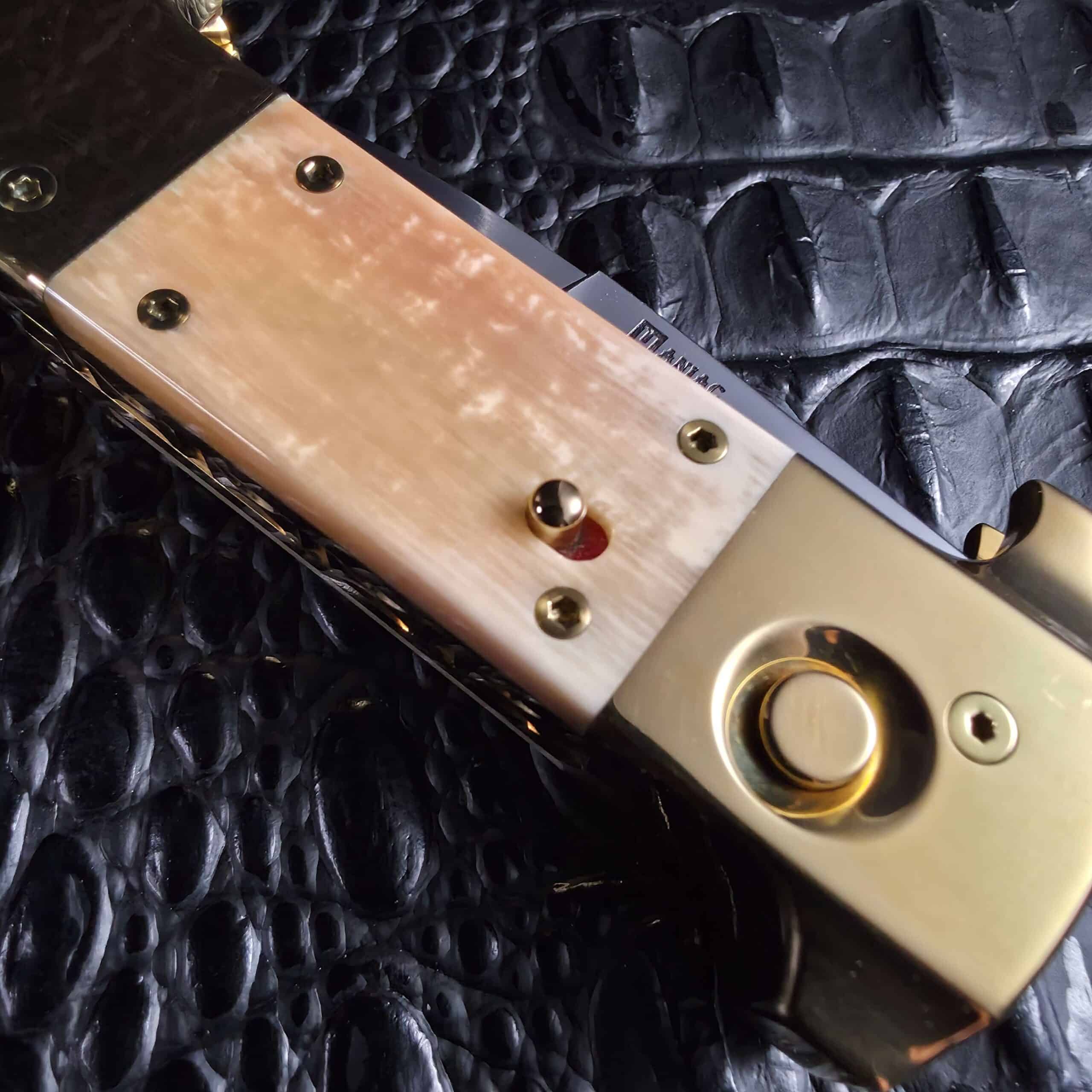 Sliding safety with red indicator and brass firing button on a Maniac Machining Stinger Custom