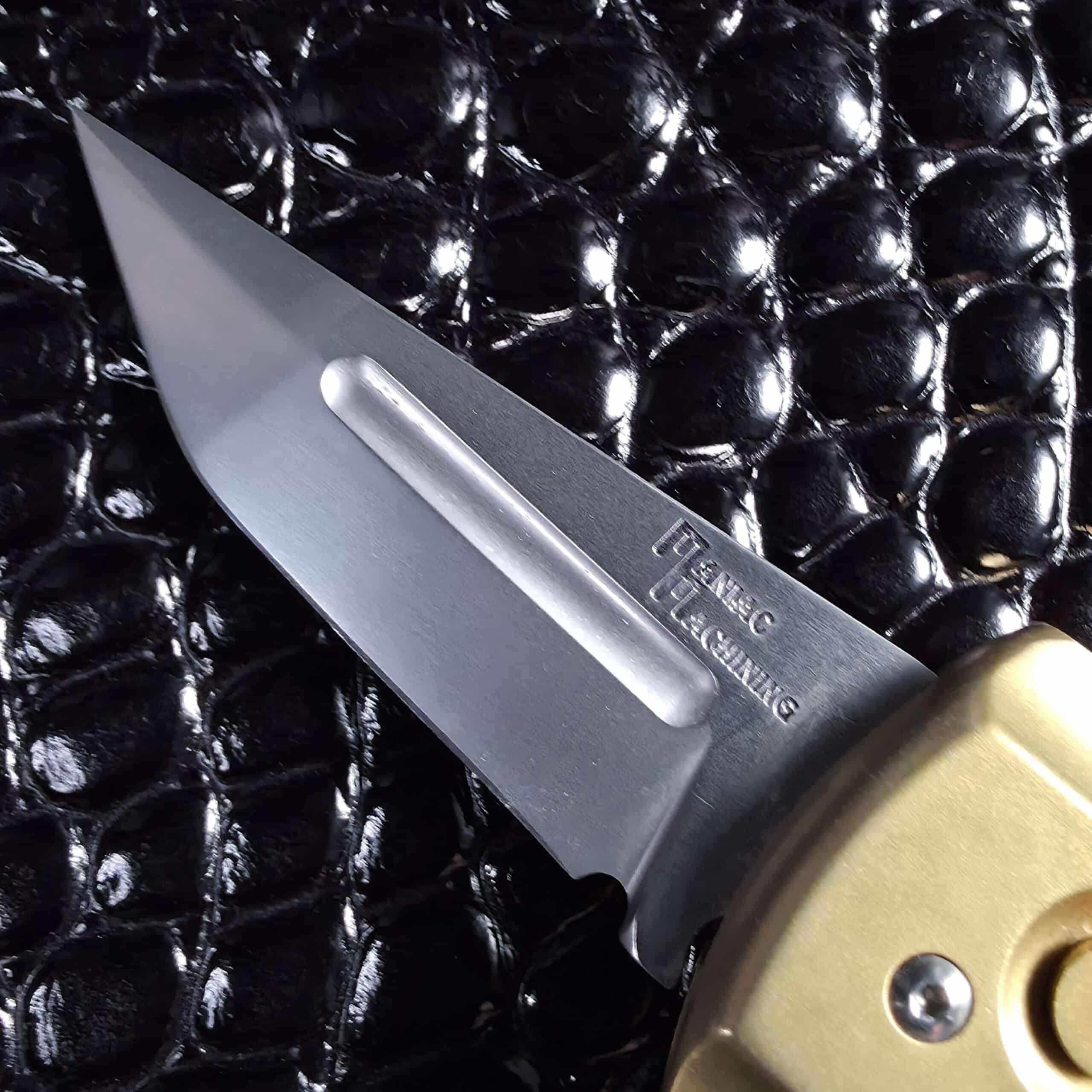Long polished fuller and Maniac Machining mark on the Stinger EDC blade