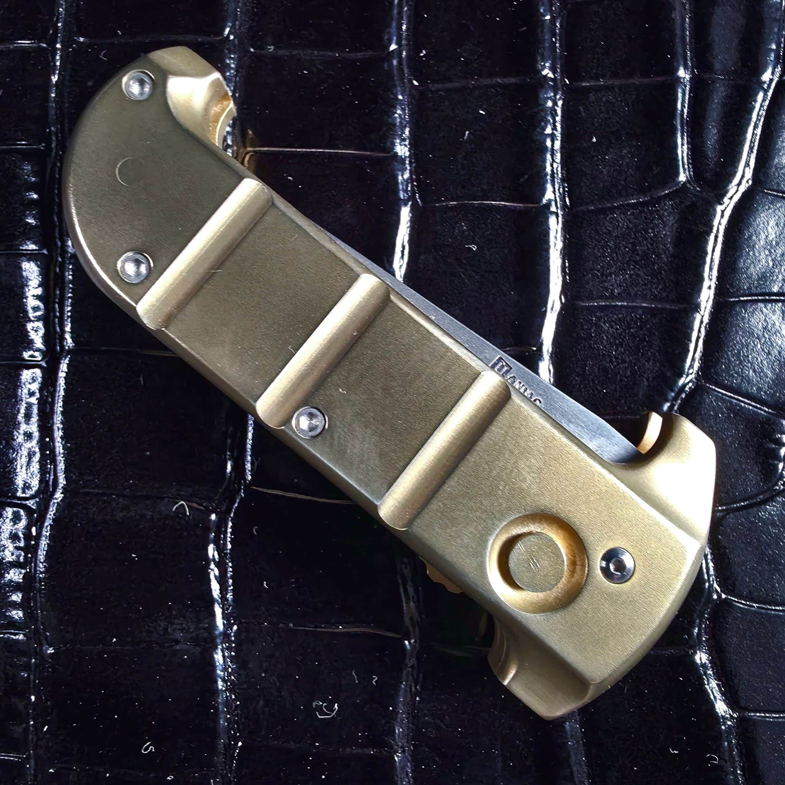 Closed Maniac Machining Stinger EDC showing solid brass handle and machined bands