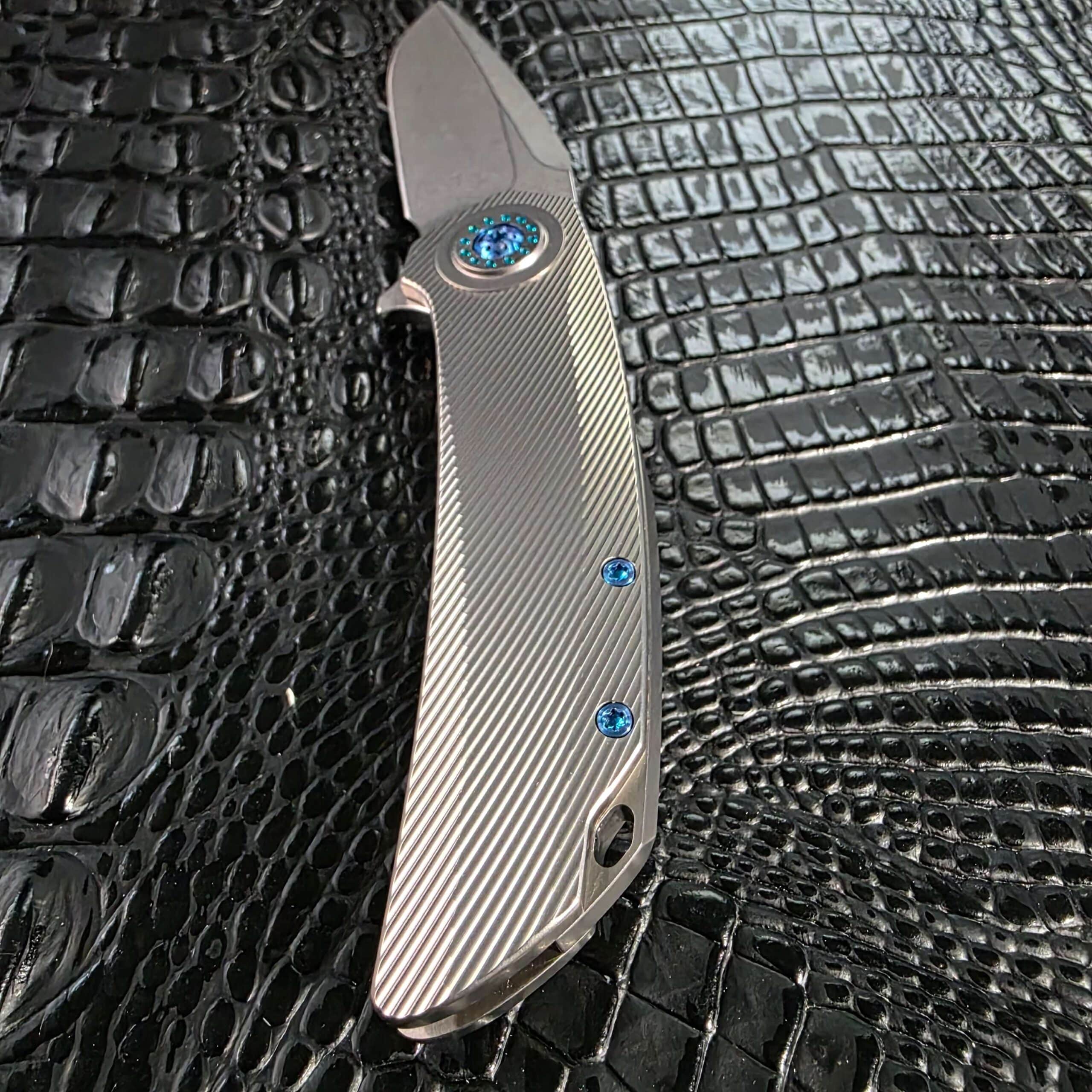 Milled titanium backspacer, lanyard hole, and pocket clip detail on the Skiff Made Blades Fugitive #0113