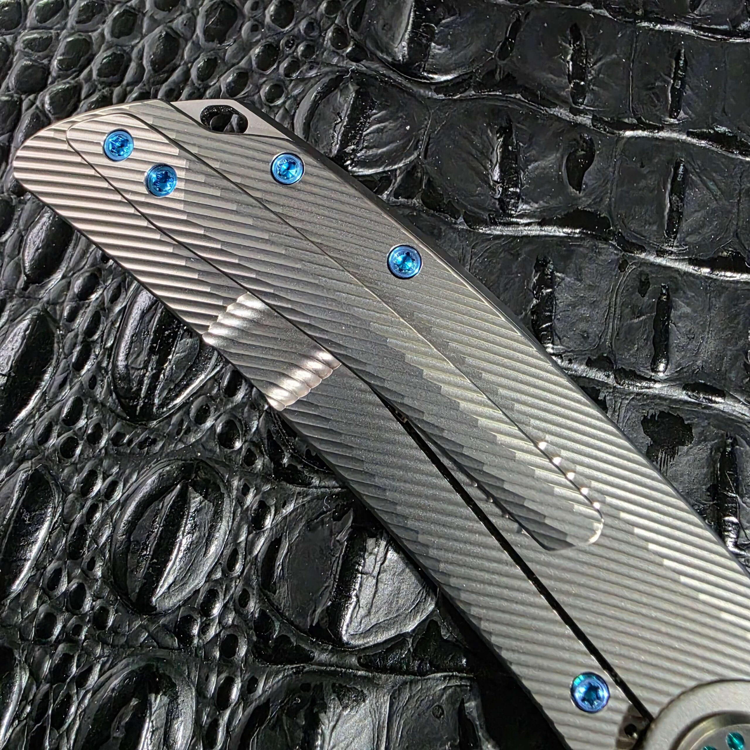 Angled view of the closed Skiff Made Blades Fugitive #0113 showing the clip, spine, and milled titanium frame