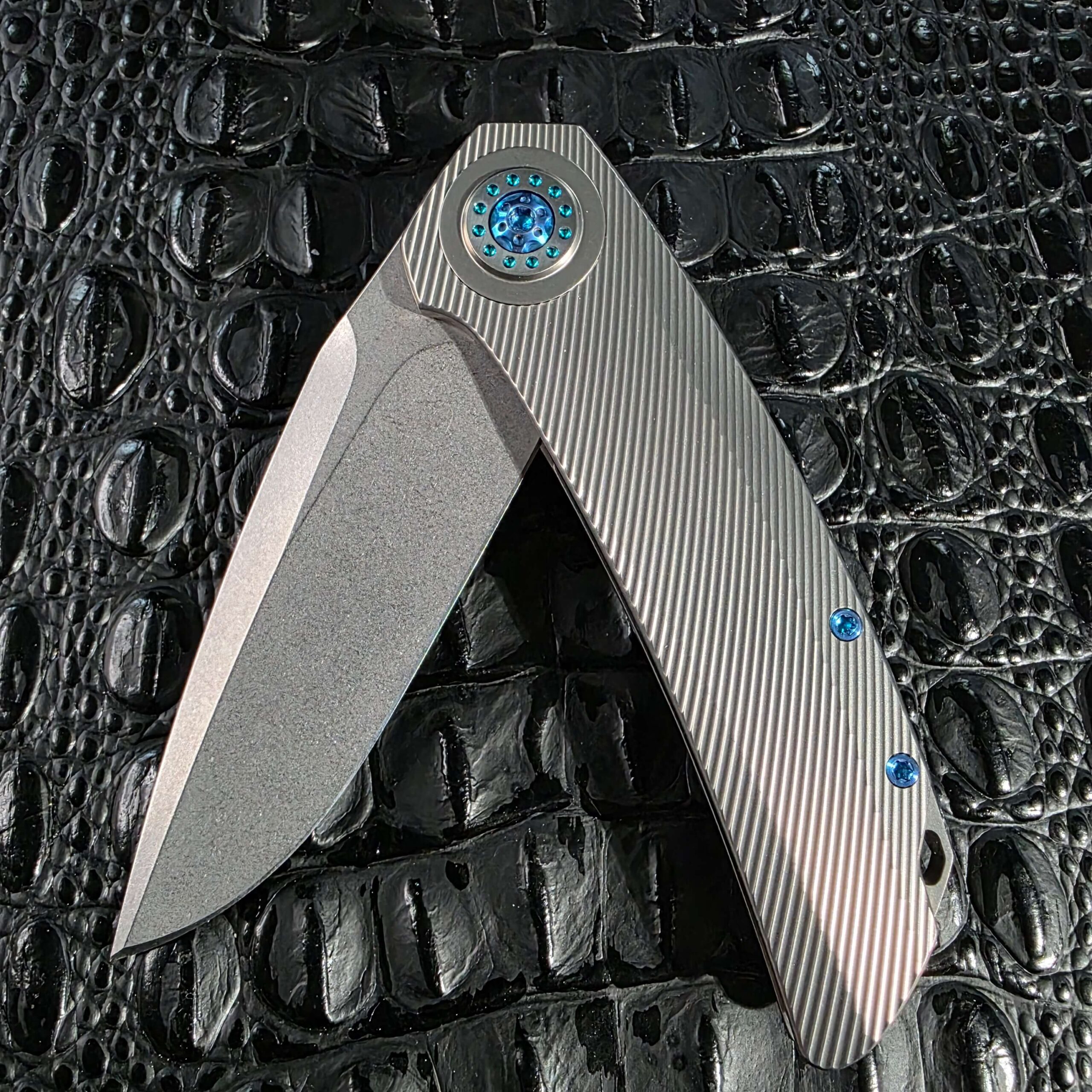 Skiff Made Blades Fugitive #0113 shown half open on the flipper, revealing the blade and frame lock