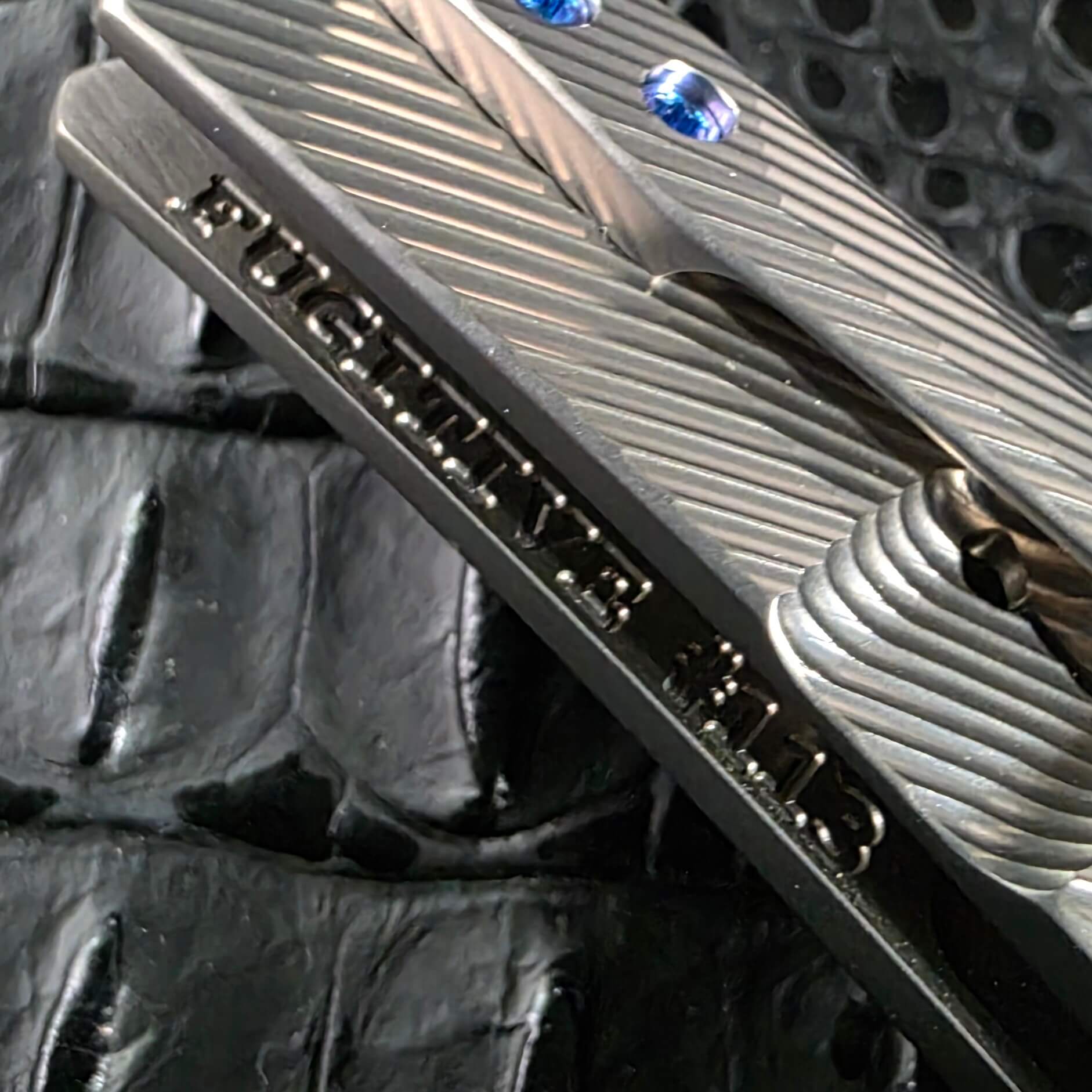 FUGITIVE #0113 serial engraving on the titanium spine of the Skiff Made Blades Fugitive