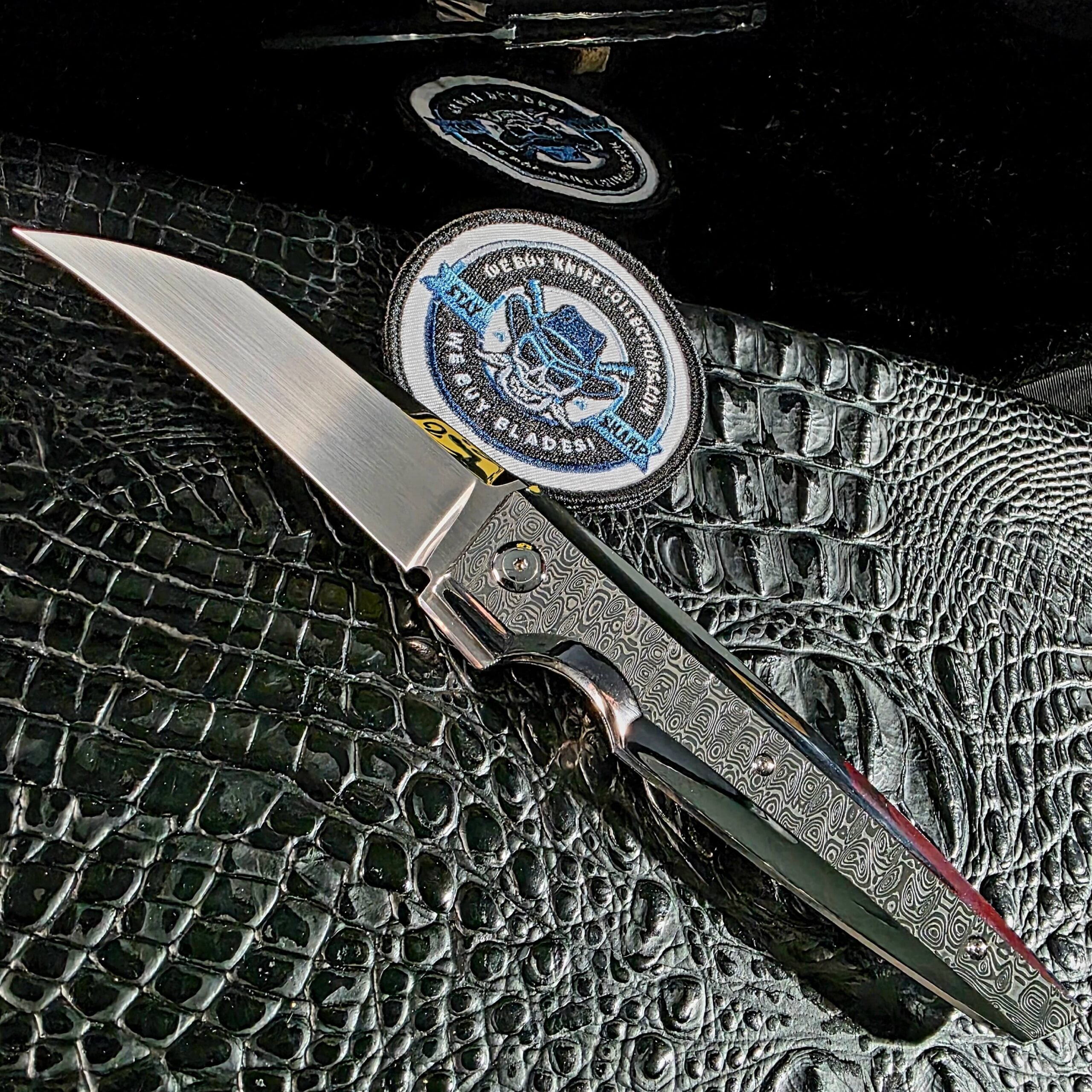 Stefano Compostella StriaXL custom flipper open on black crocodile leather with mirror-polished Damasteel Ladder scales and satin Erasteel APZ10 blade