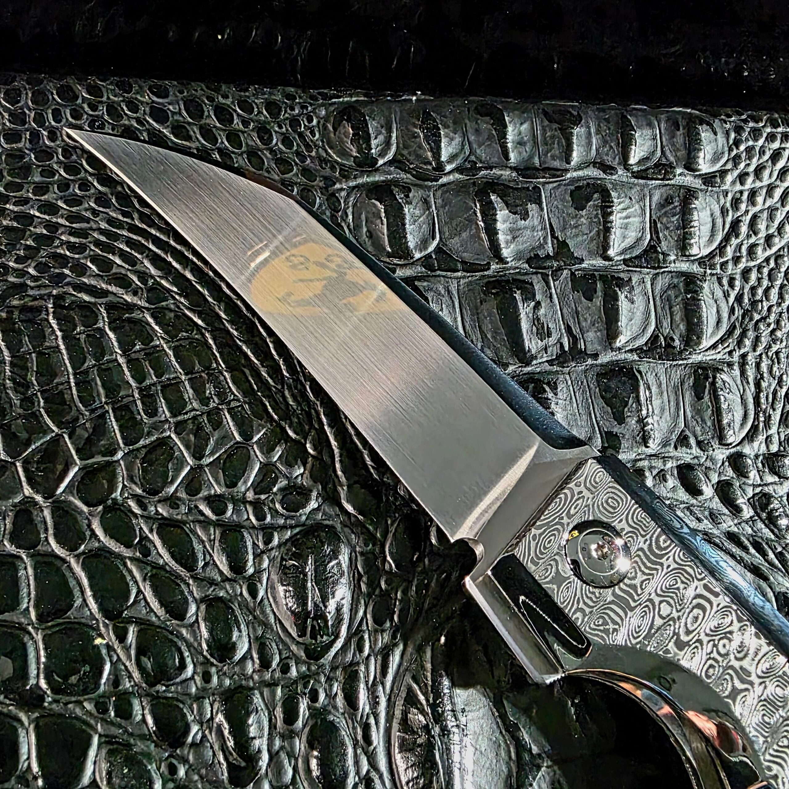 Hand-ground satin finish on the Erasteel APZ10 blade of the Stefano Compostella StriaXL custom flipper