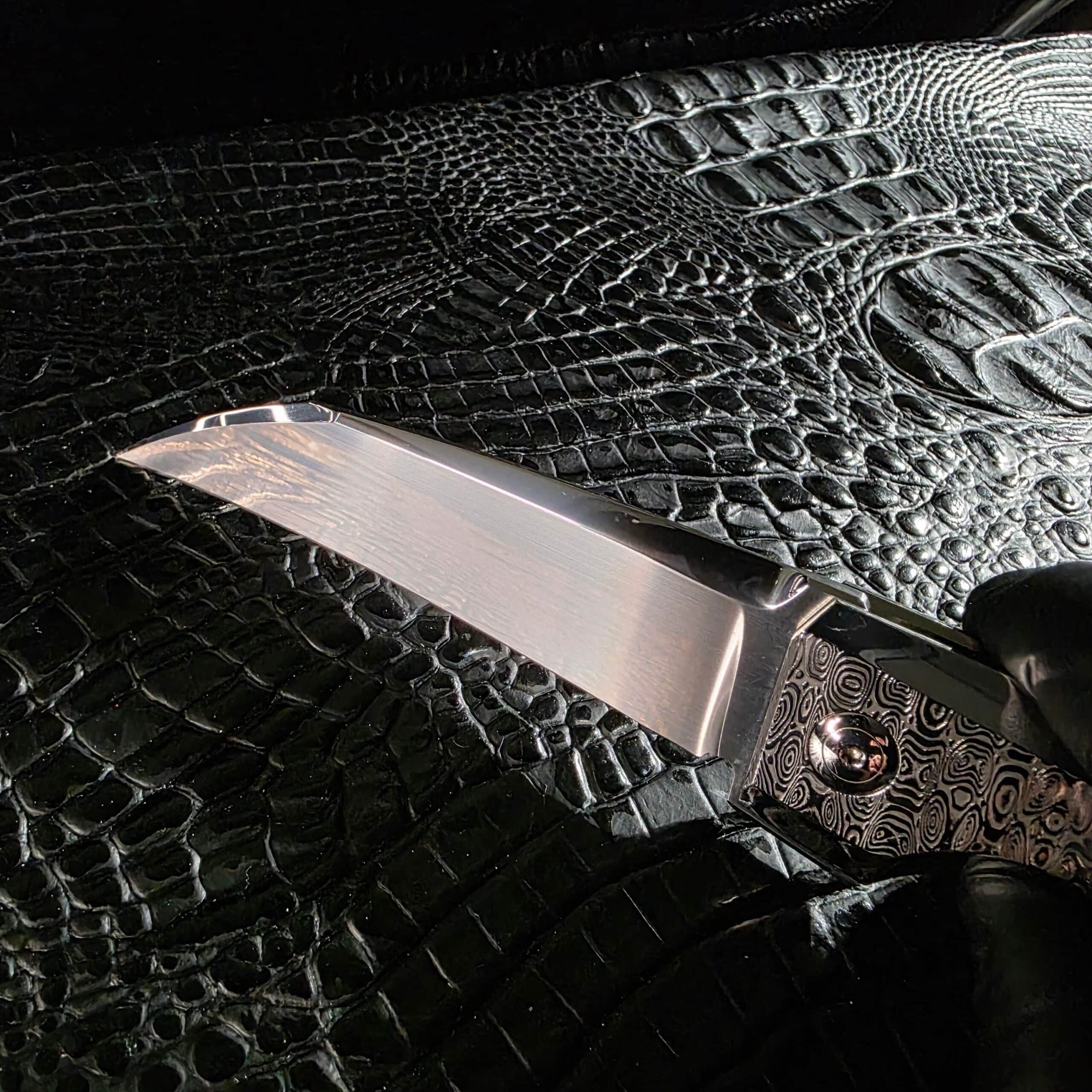 Close detail of the satin finish and flat grind on the Erasteel APZ10 blade of the Stefano Compostella StriaXL