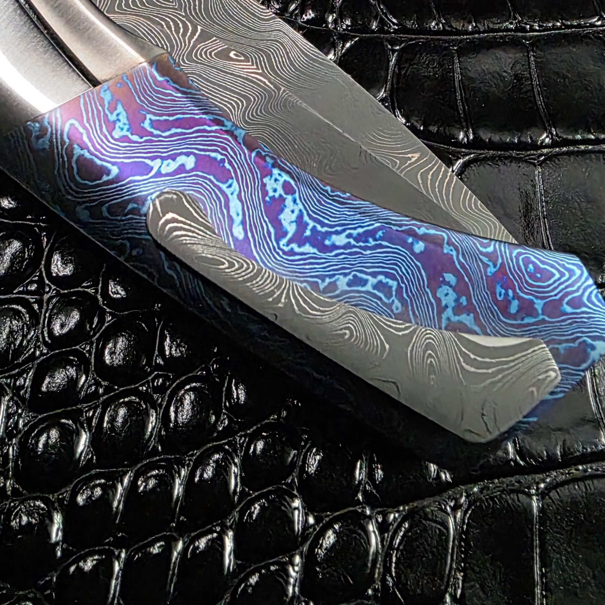 Detail of the damascus clip, mokuti scale and blade on the Todd Fischer Kamehameha