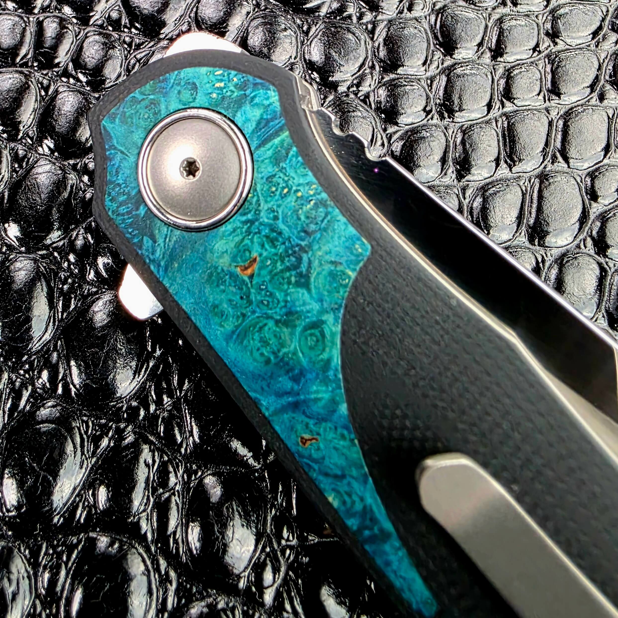 Teal burl inlay and titanium pocket clip on the 3LegDog M10 in one frame