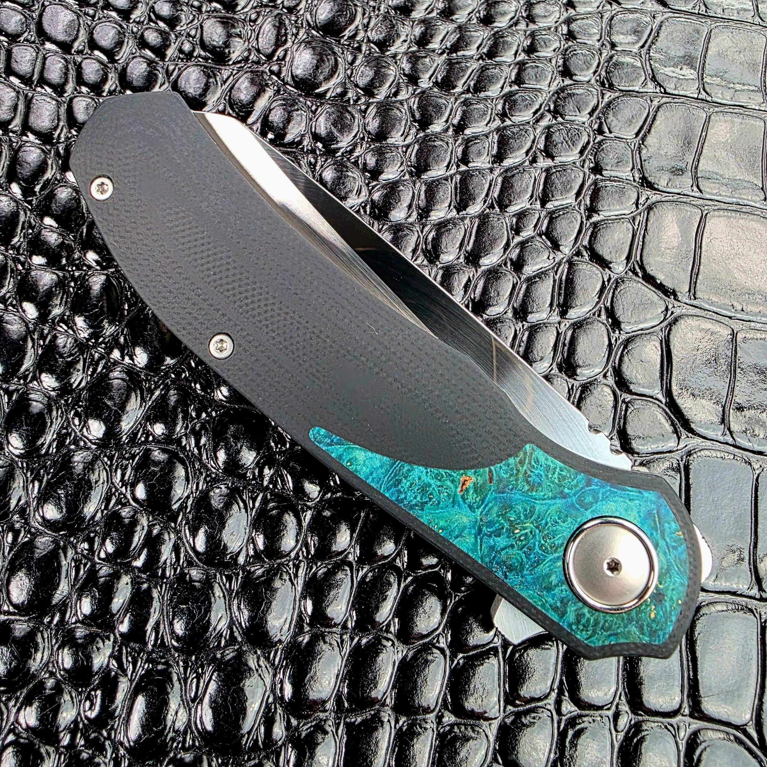3LegDog M10 closed on the show side, 4.25 inches of black G10 with teal burl at the pivot