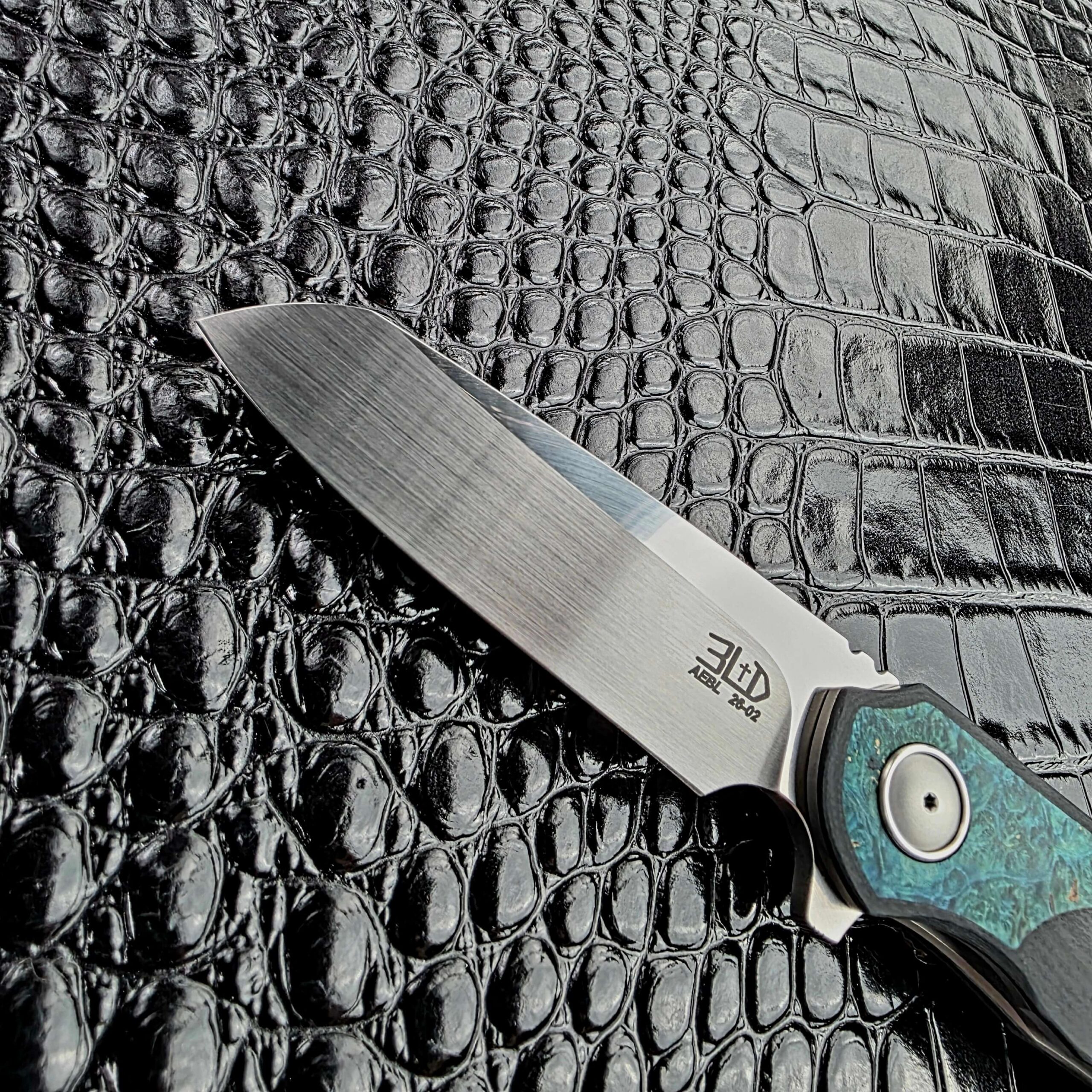 Hand-rubbed satin AEB-L drop point blade on the 3LegDog M10
