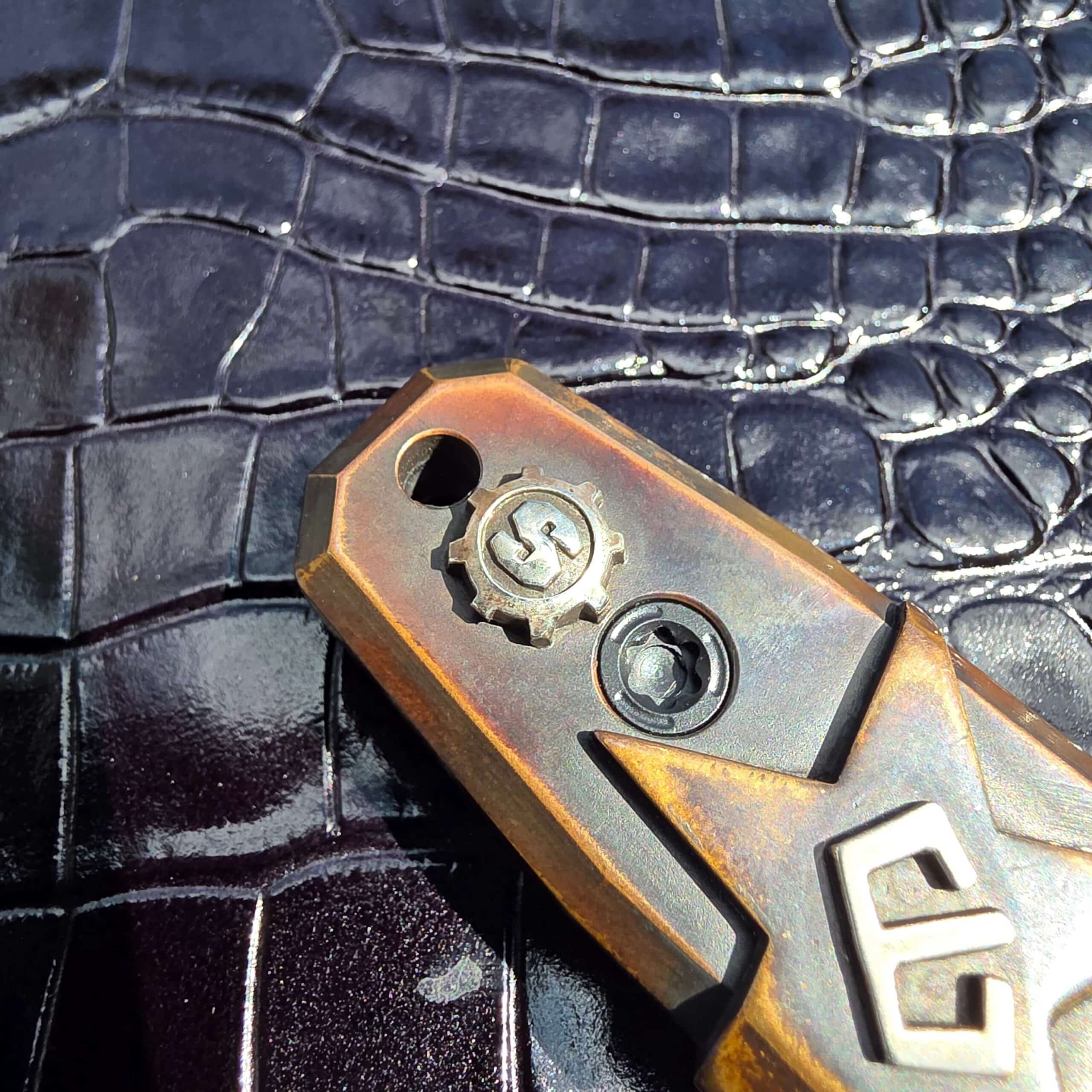Blackside Customs crown emblem inset into a carved star on the Plan B copper handle