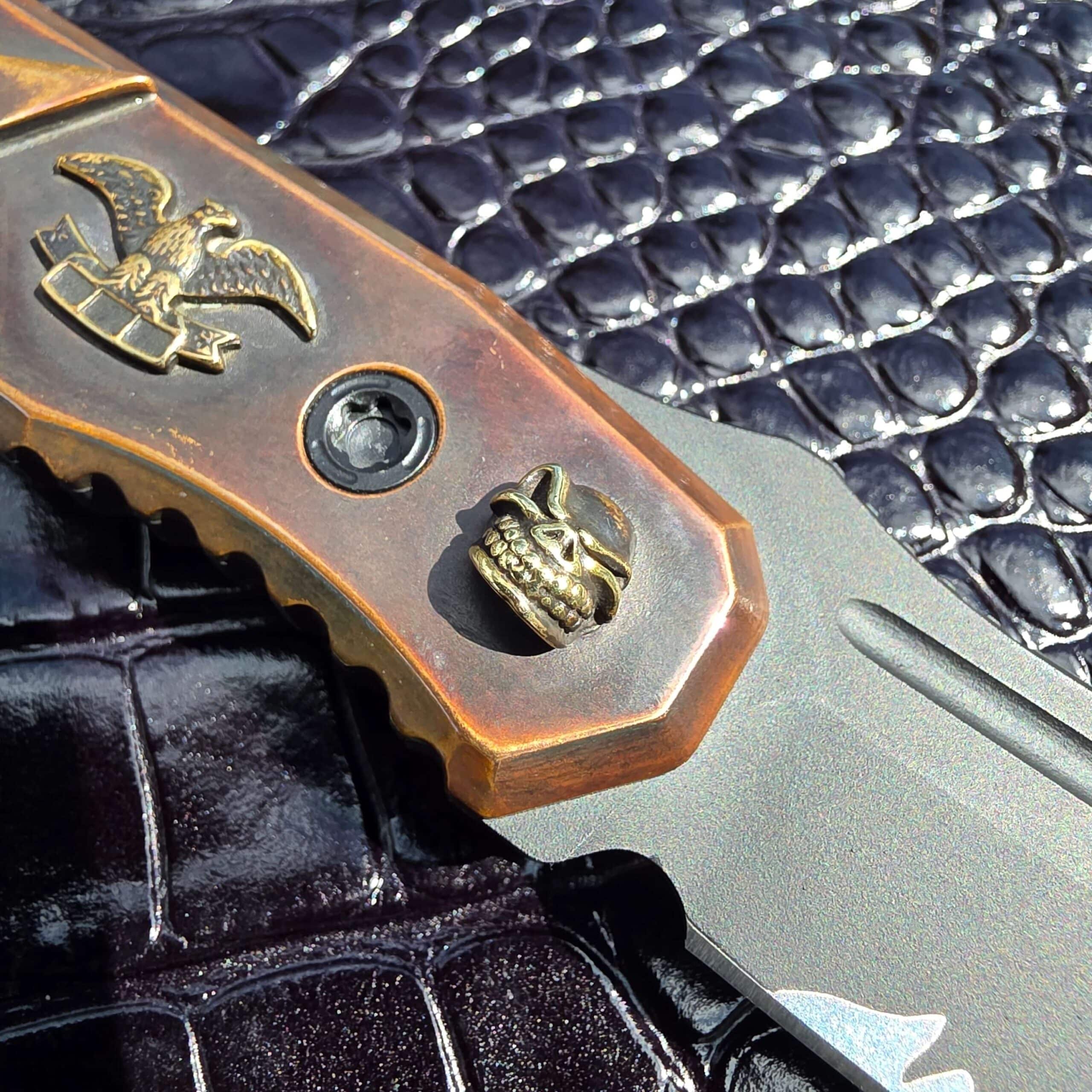 Cast brass American eagle holding a banner on the Blackside Customs Plan B handle