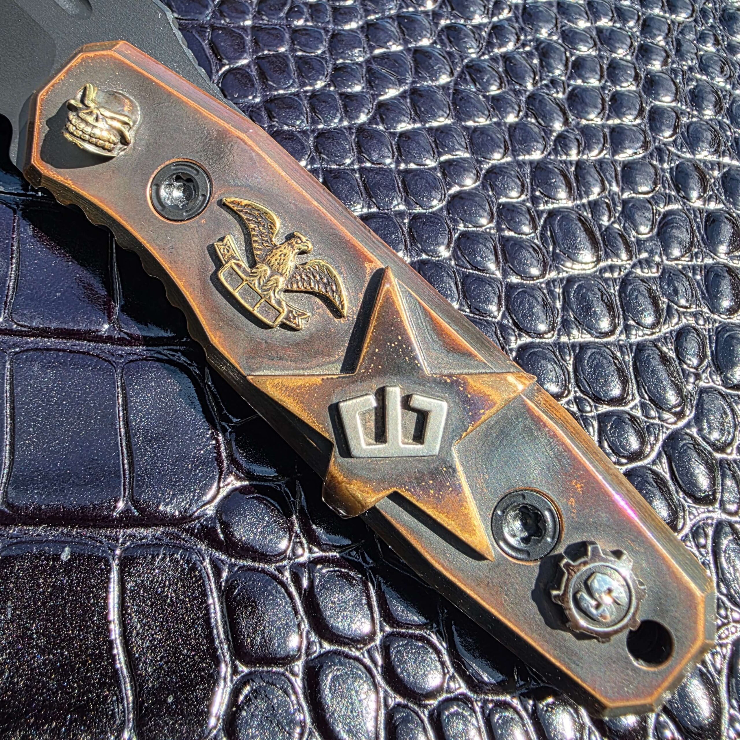 Hand-carved copper handle on the Blackside Customs Plan B with Starlingear skull, cast eagle and Blackside crown