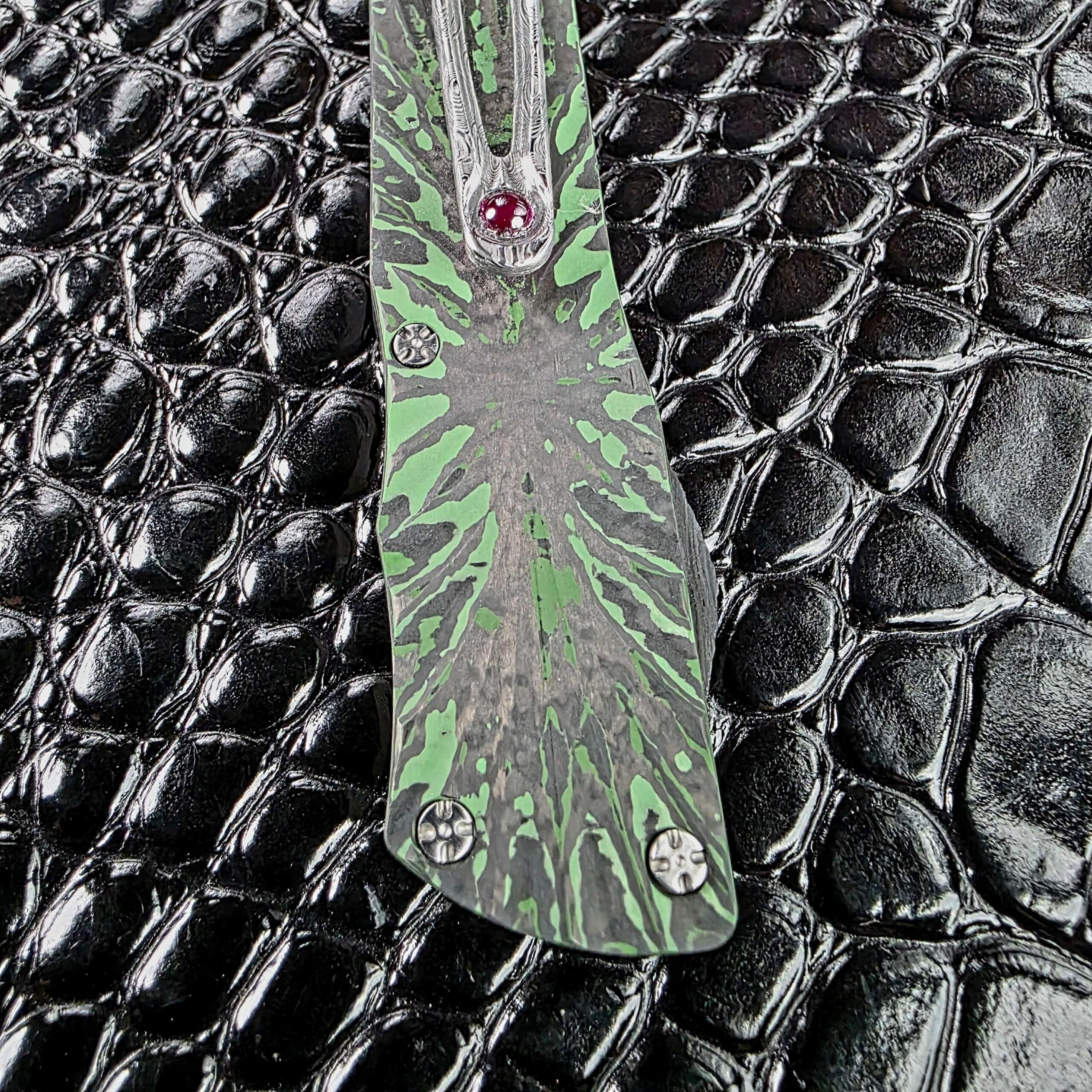 Green and black carbon fiber composite with a starburst figure on the Brian Tighe Tighe Twist OTF
