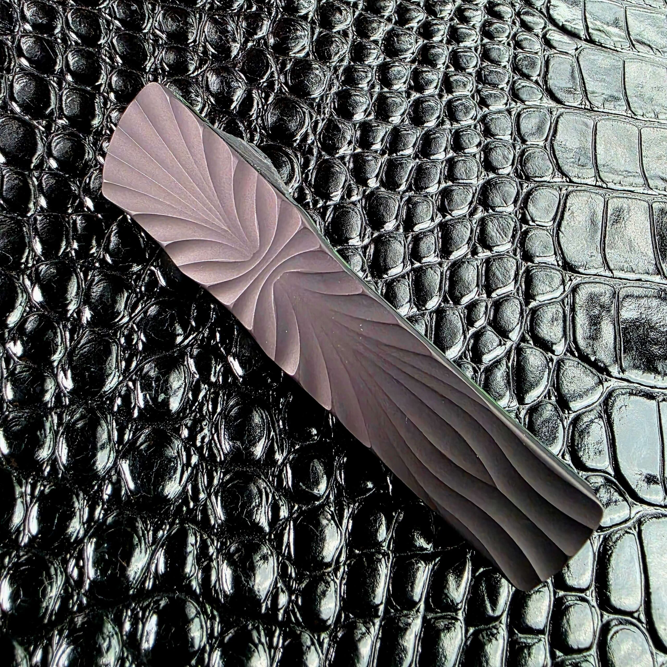 Brian Tighe Tighe Twist OTF closed, showing the full fluted titanium handle face