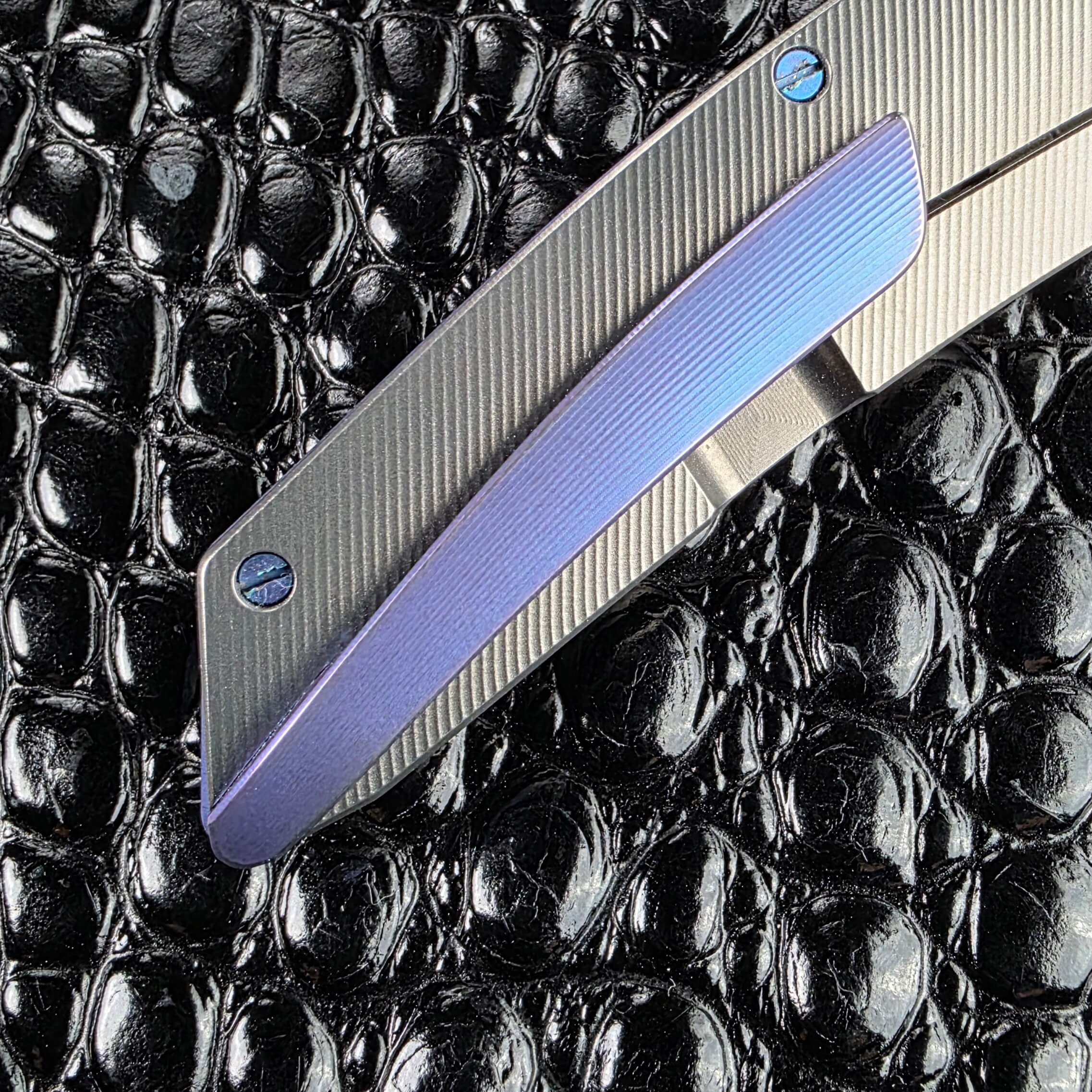 Blue Chameleon anodised titanium pocket clip detail on the Hog House Model T Gen 2