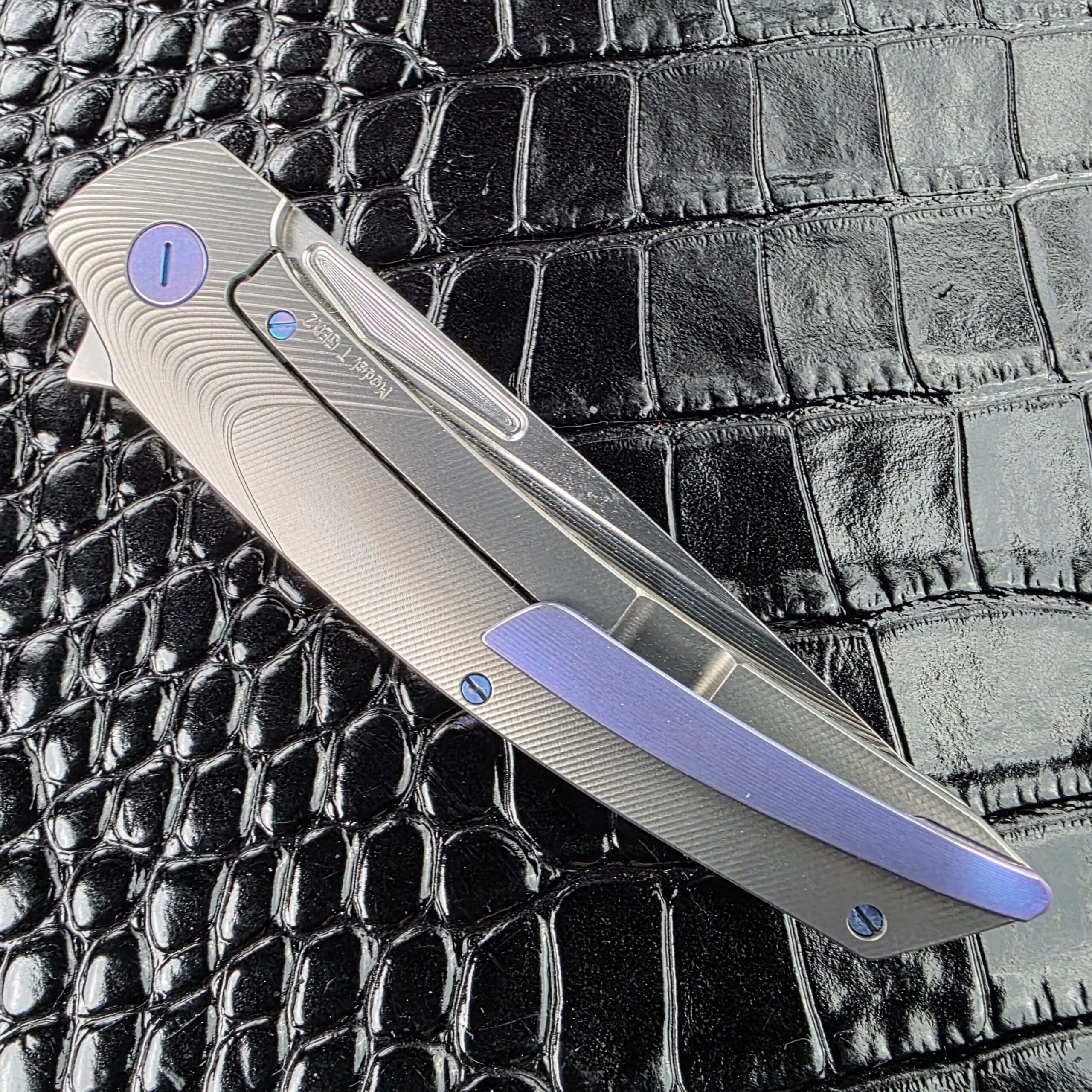Hog House Model T Gen 2 closed on the clip side with Blue Chameleon titanium pocket clip
