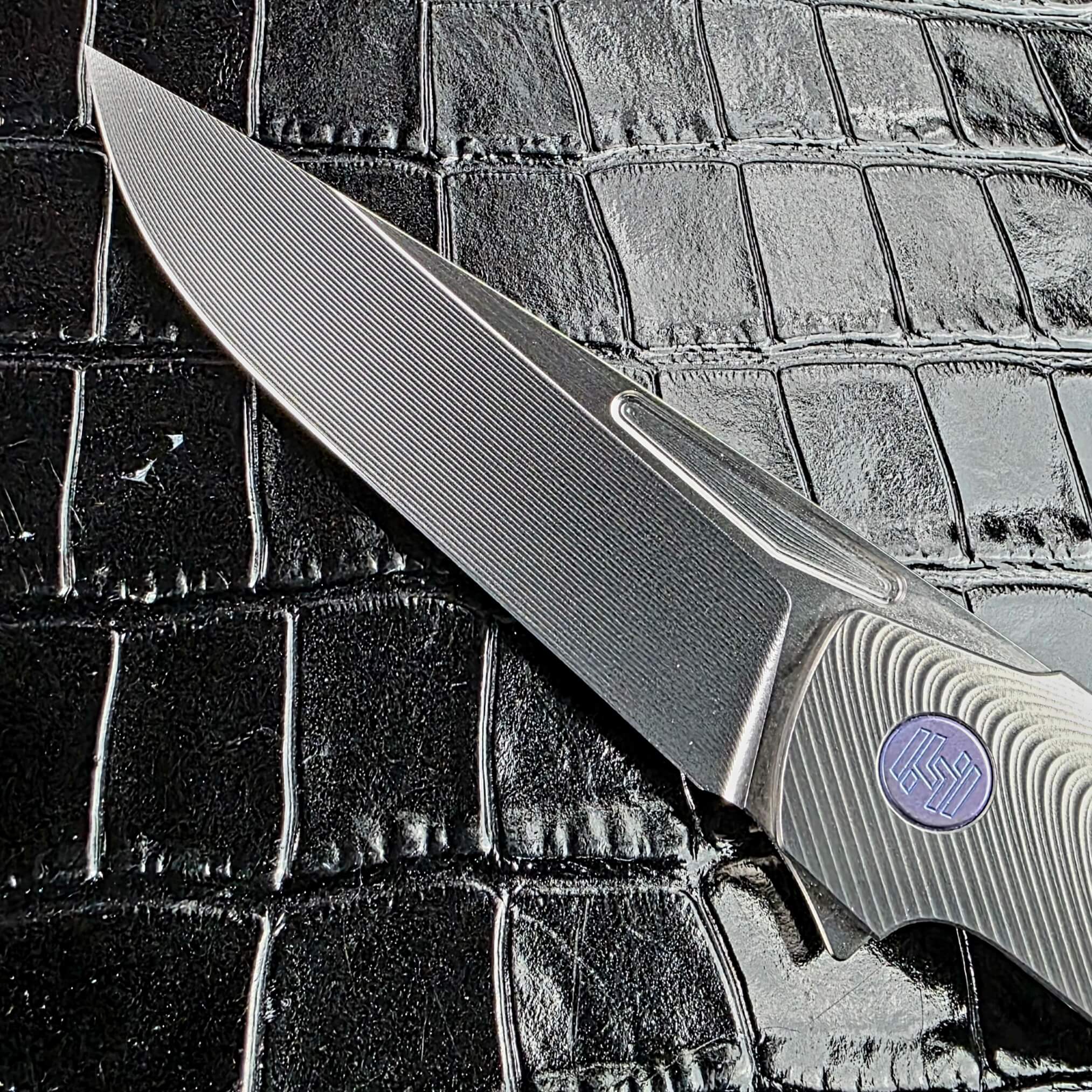 RWL-34 blade with bright satin finish and elongated fuller on the Hog House Model T Gen 2