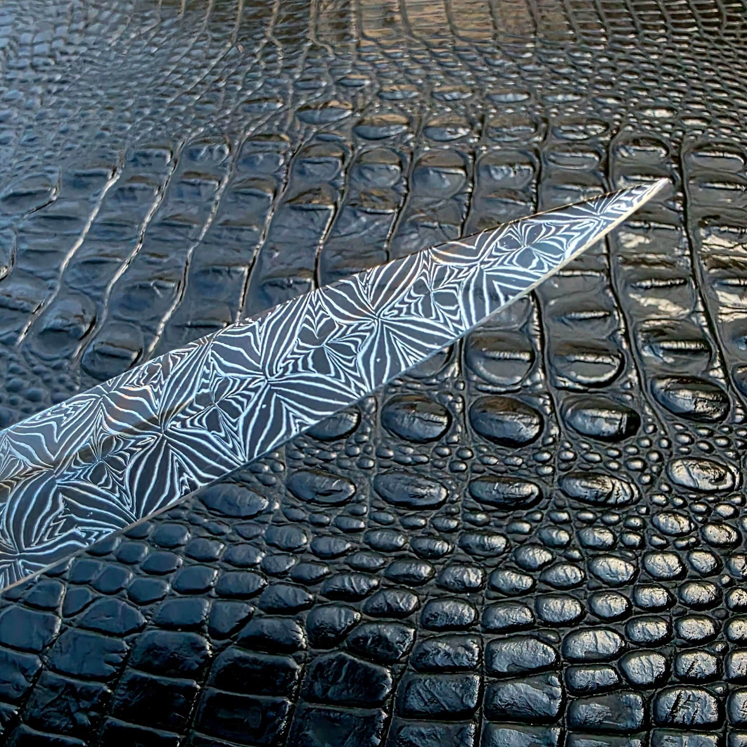 Mosaic damascus running across the flat of the La Cantina Sally #453 blade