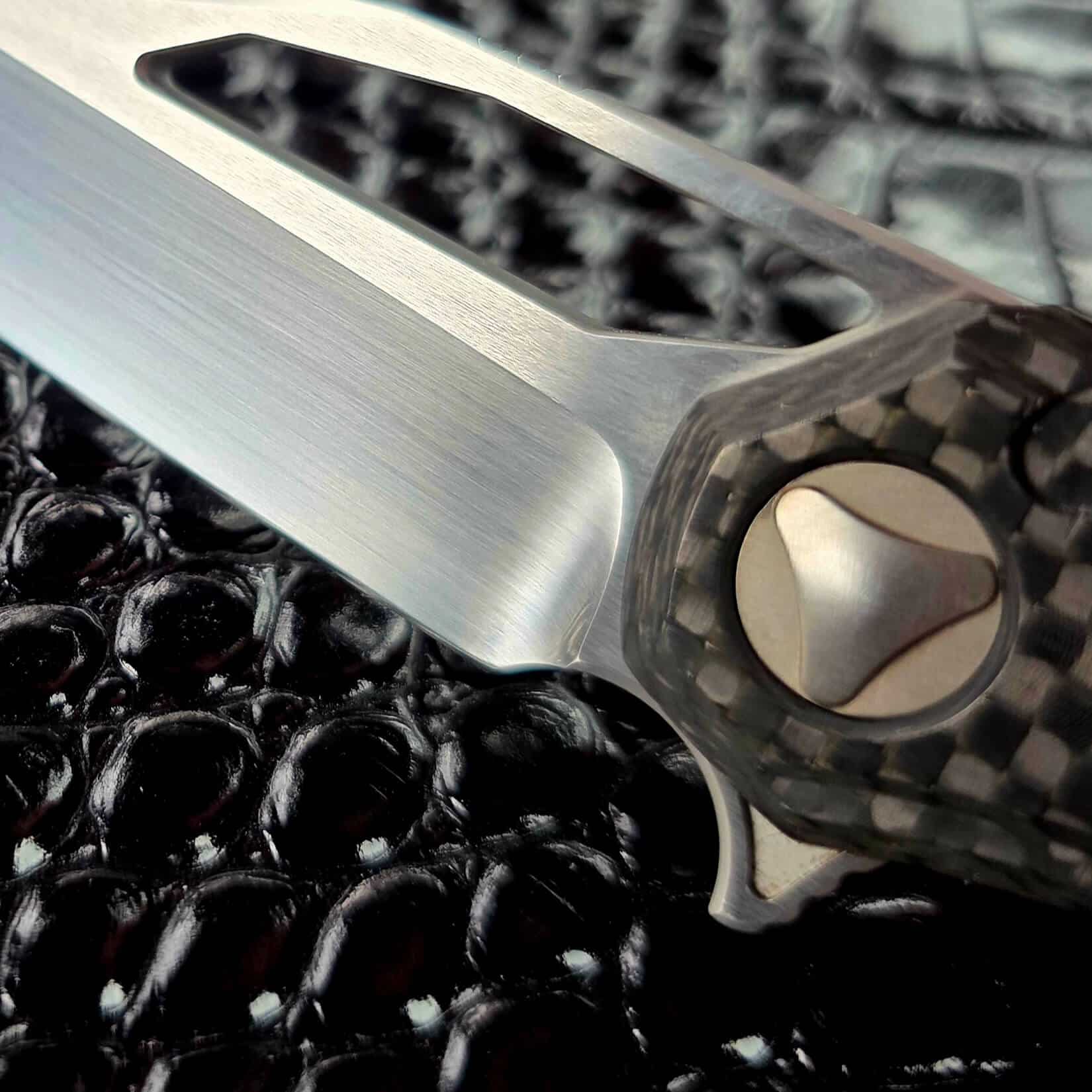 Domed pivot with triangle drive on the Marfione Custom Sigil, set in 3D milled carbon fiber