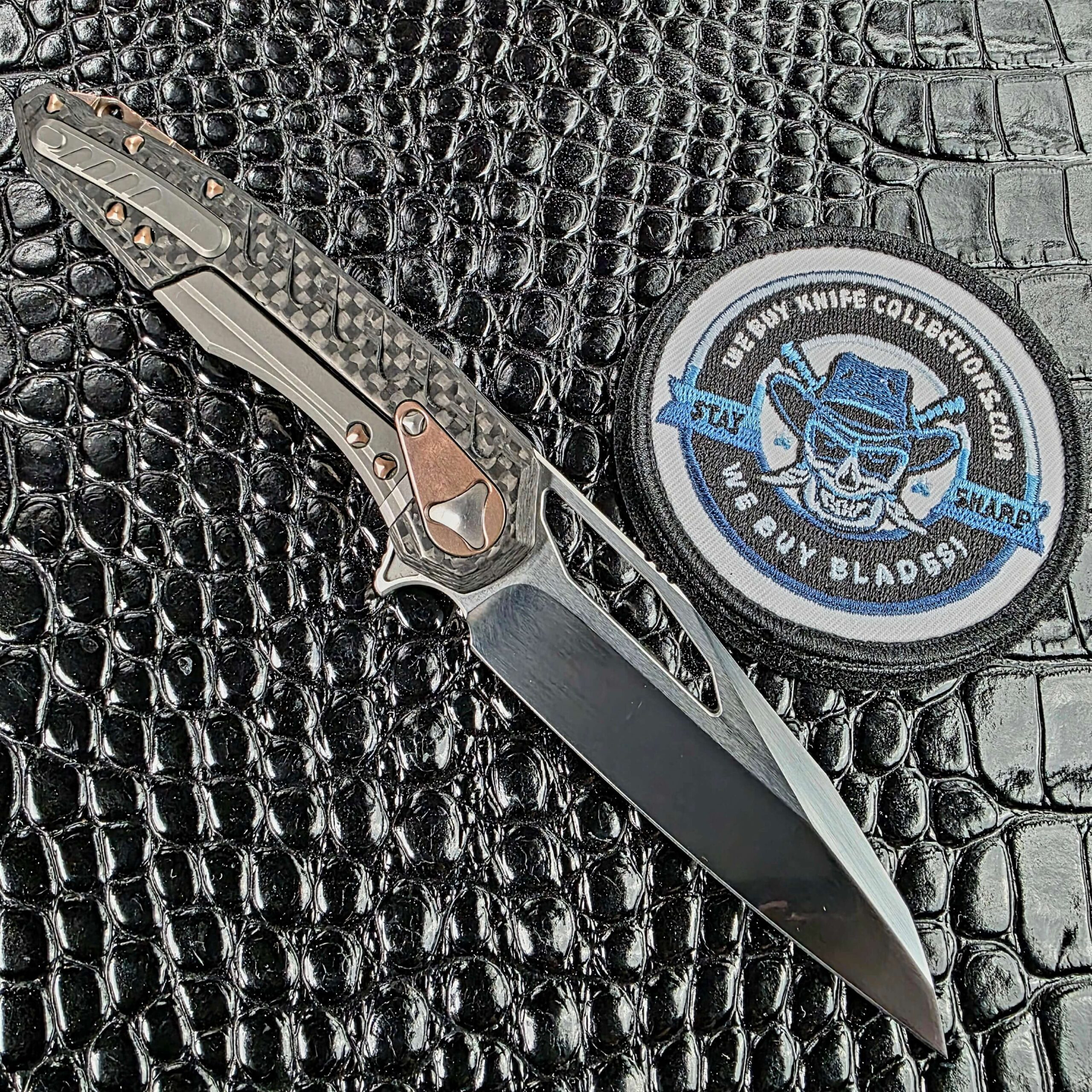 Marfione Custom Sigil open on the lock side, showing the titanium sub-frame lockbar inset into the carbon fiber