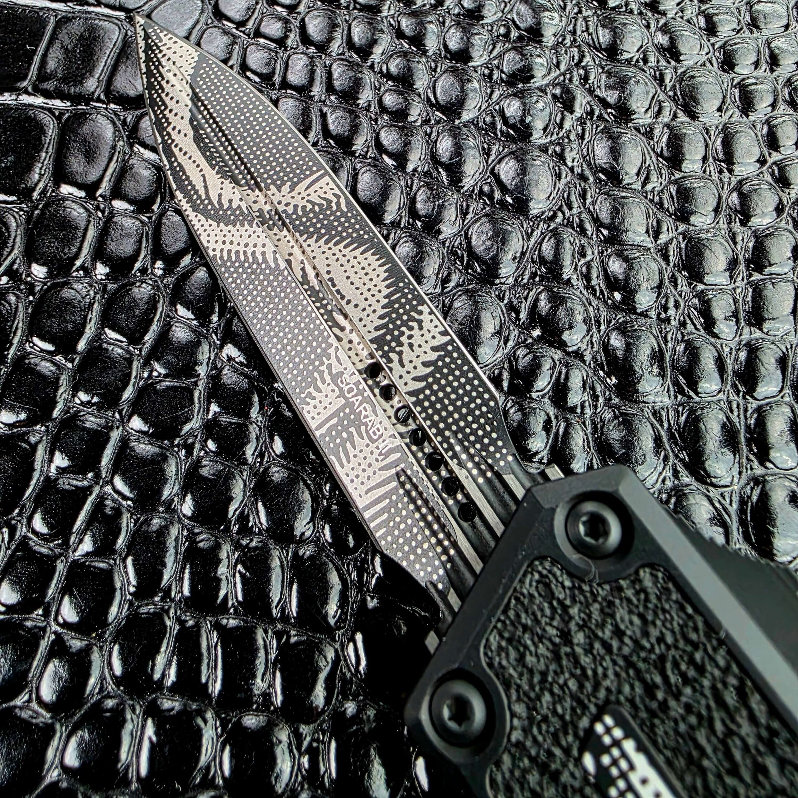 Blade and handle of the Microtech Scarab II Gen III showing the camo pattern carried across both