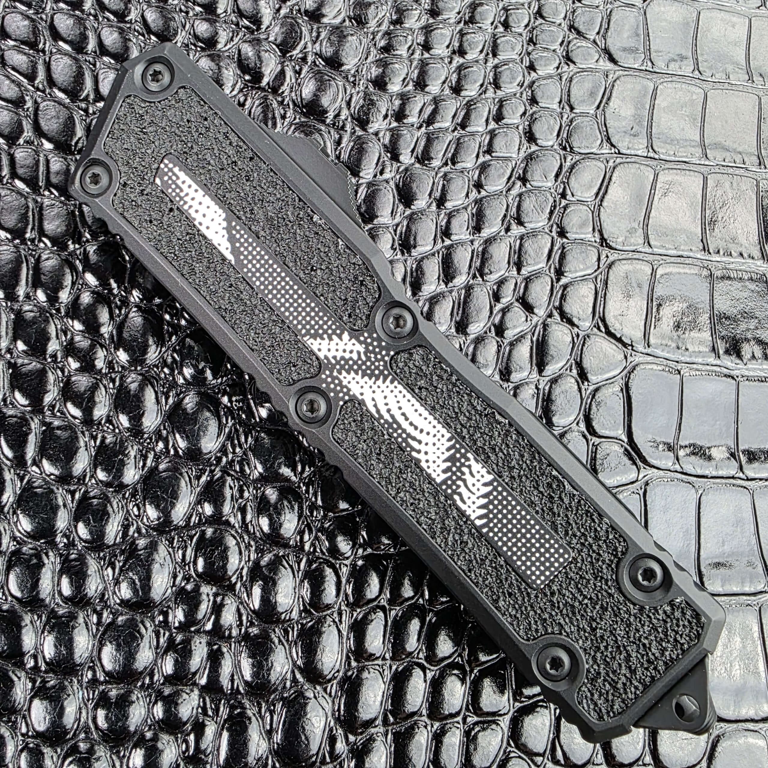 Microtech Scarab II Gen III closed on the show side, 5.75 inches of aluminium with Geo Trace Camo inserts