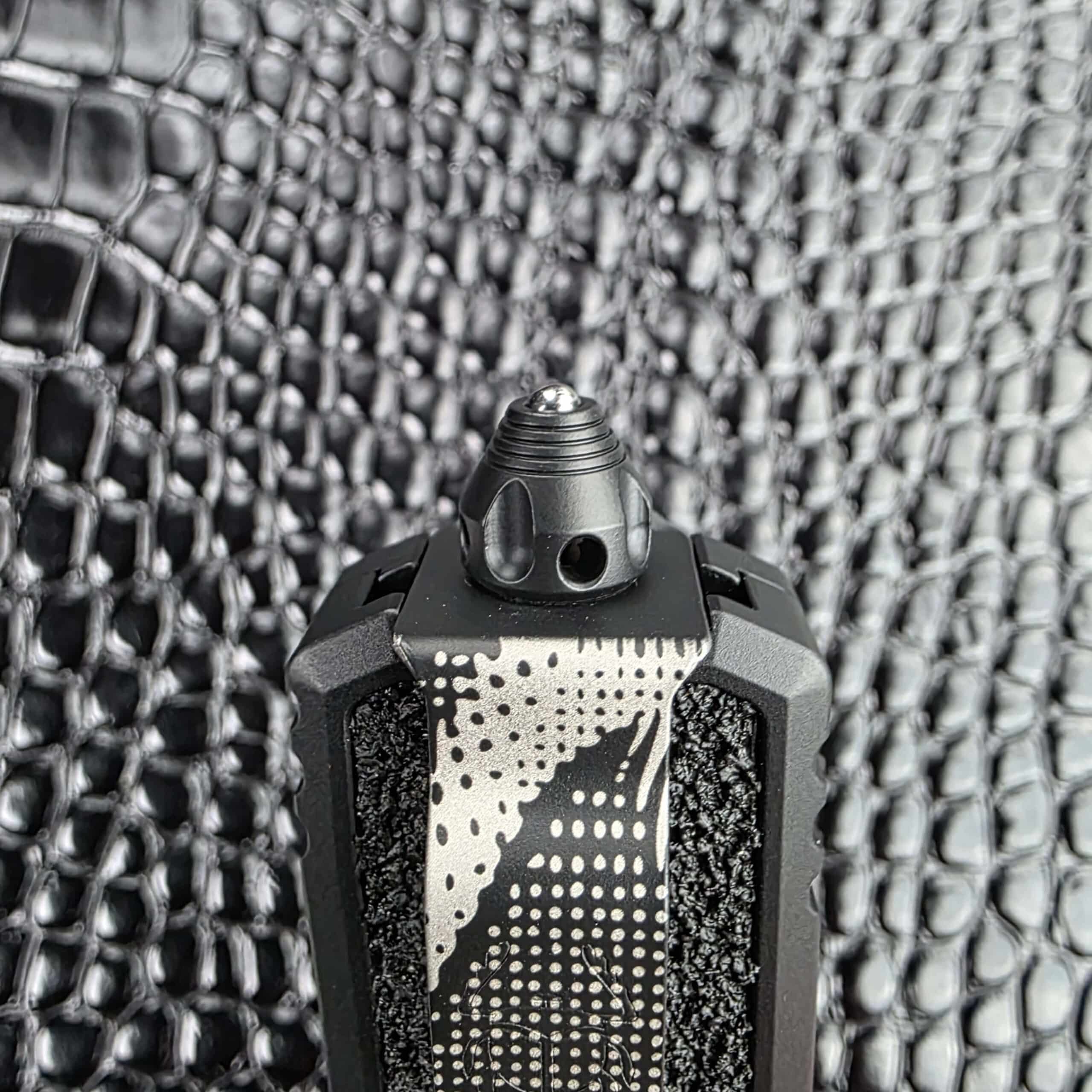 Glass breaker fitted at the butt of the Microtech Scarab II Gen III