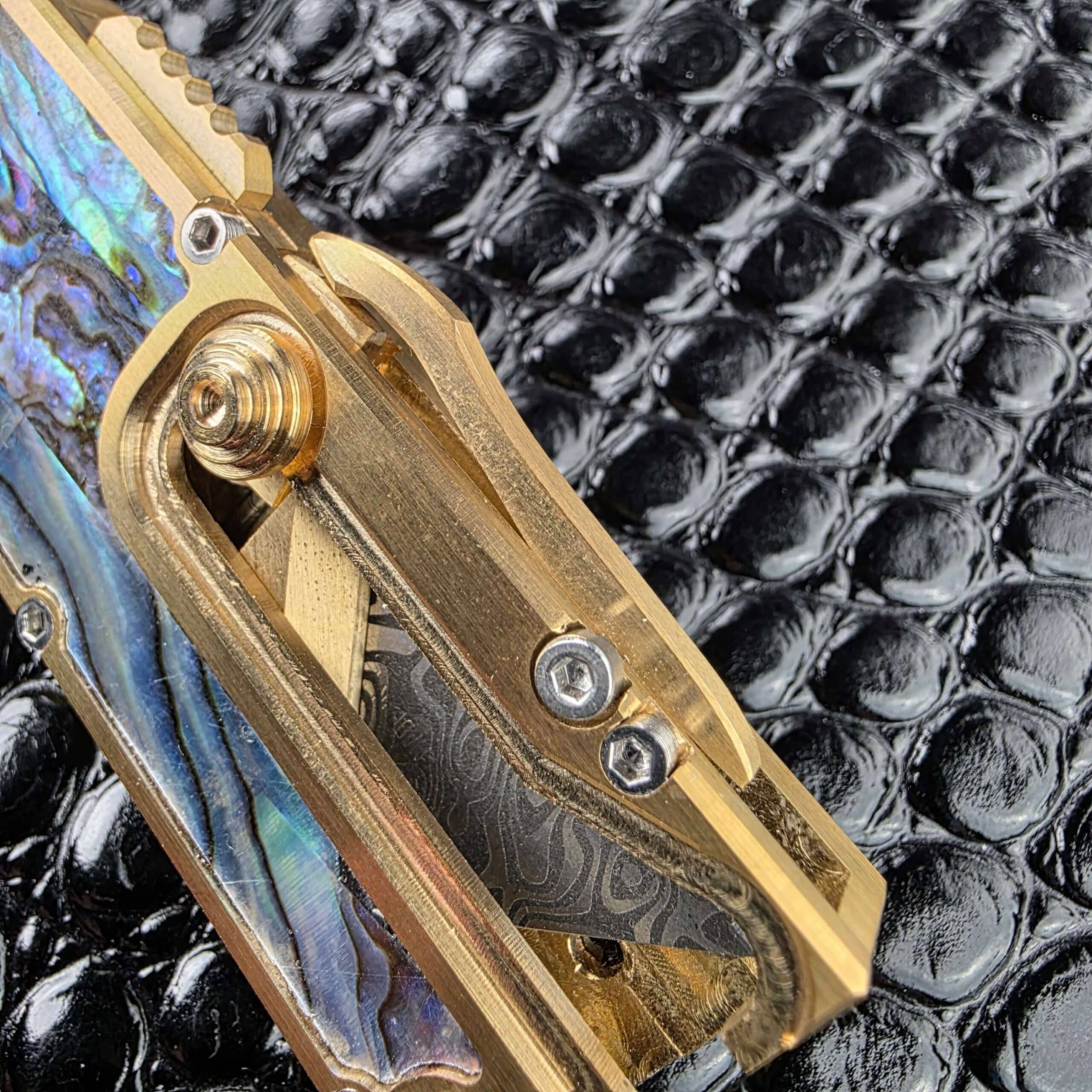 Macro of the abalone shell against machined brass on the Miroc Razor Knife