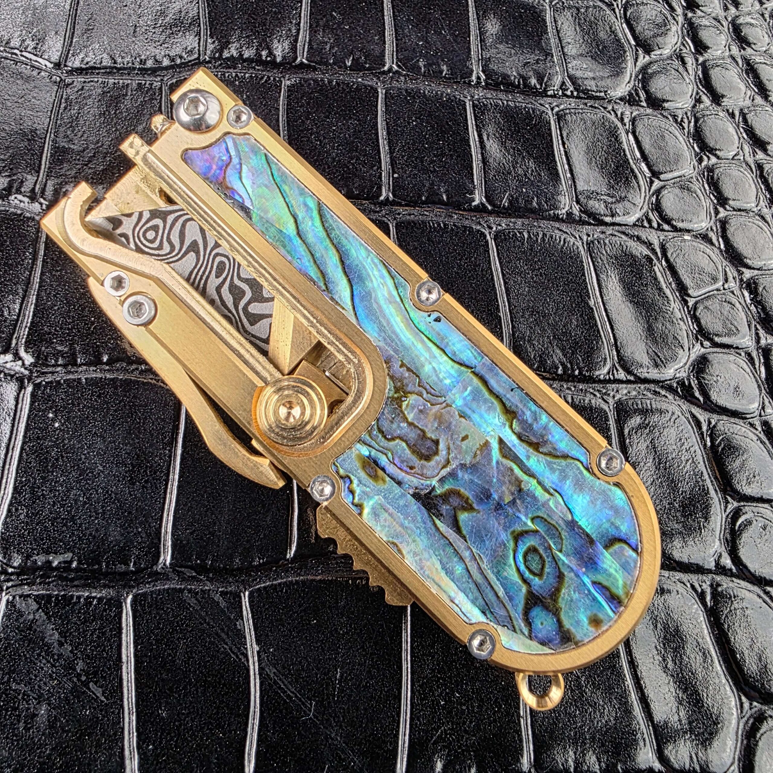 Side actuator and safety lockout on the brass chassis of the Miroc Razor Knife