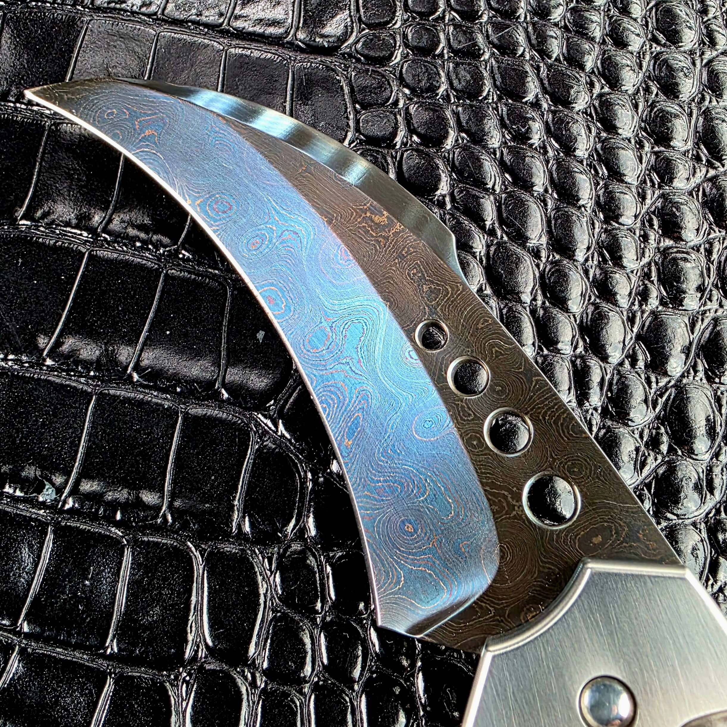 Brad Vice blued damascus pattern and graduated holes on the Reese Weiland Large Rastor blade