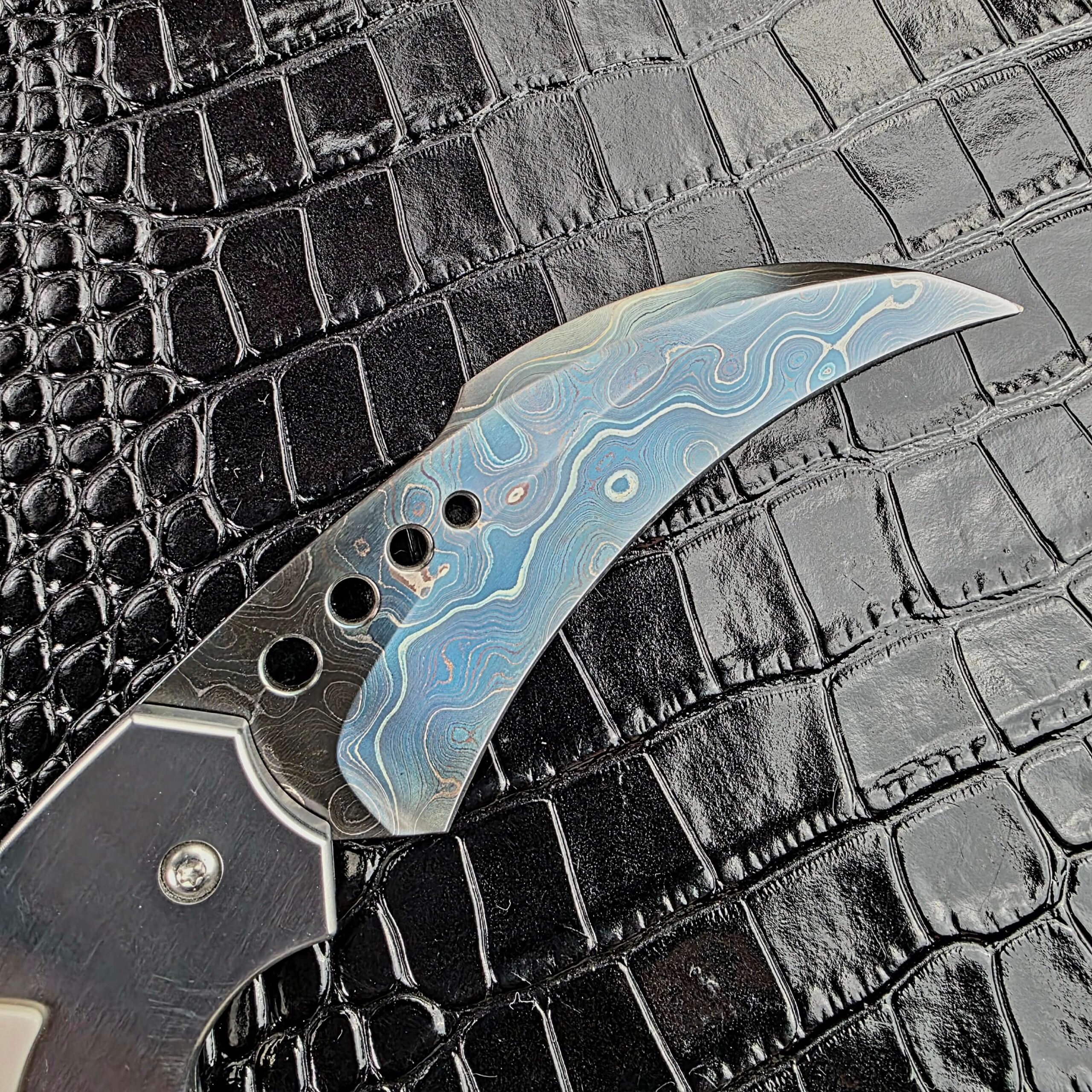 Brad Vice blued damascus pattern and graduated holes on the Reese Weiland Large Rastor blade
