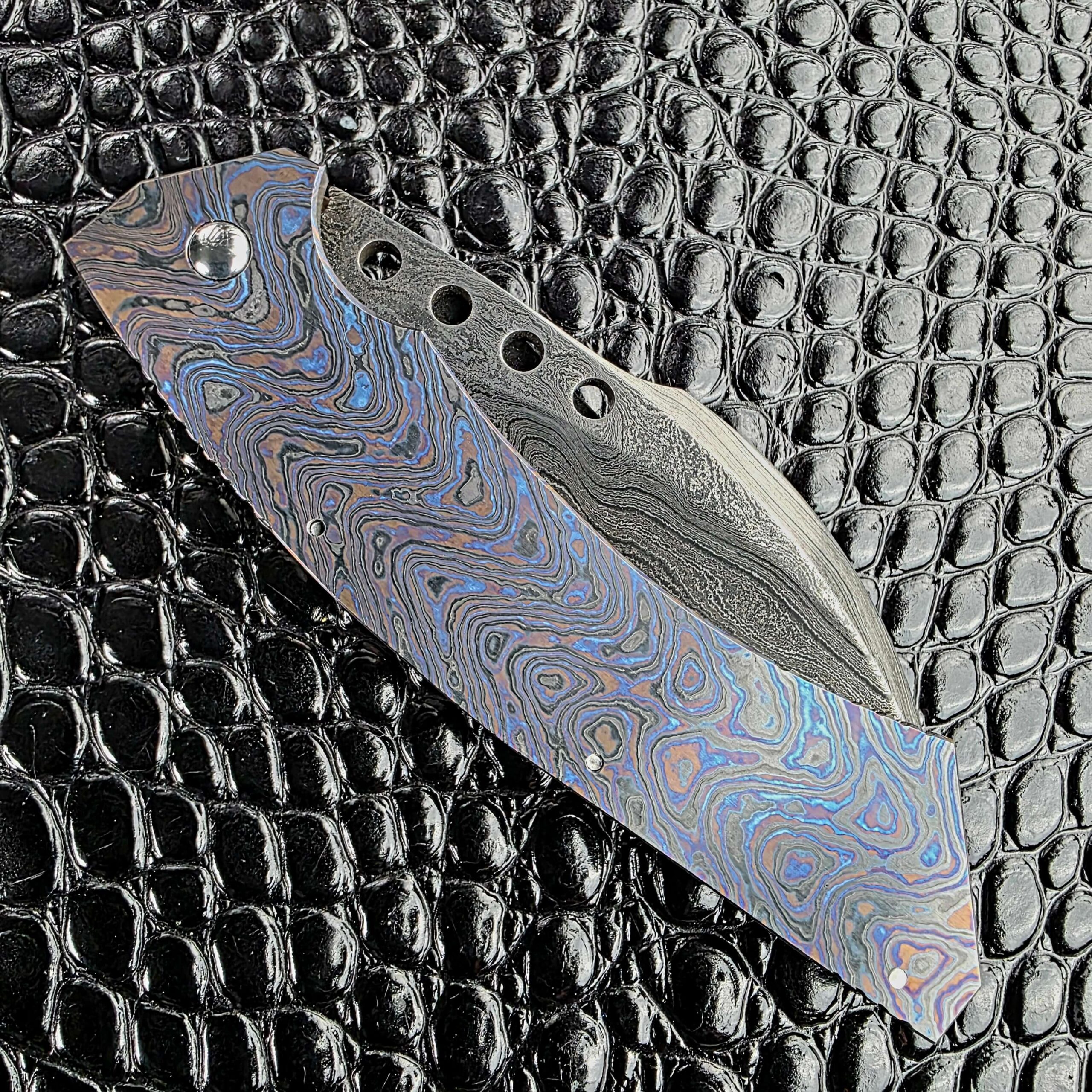 Reese Weiland Hawkbill 2nd Gen closed, showing the full Timascus frame on the show side
