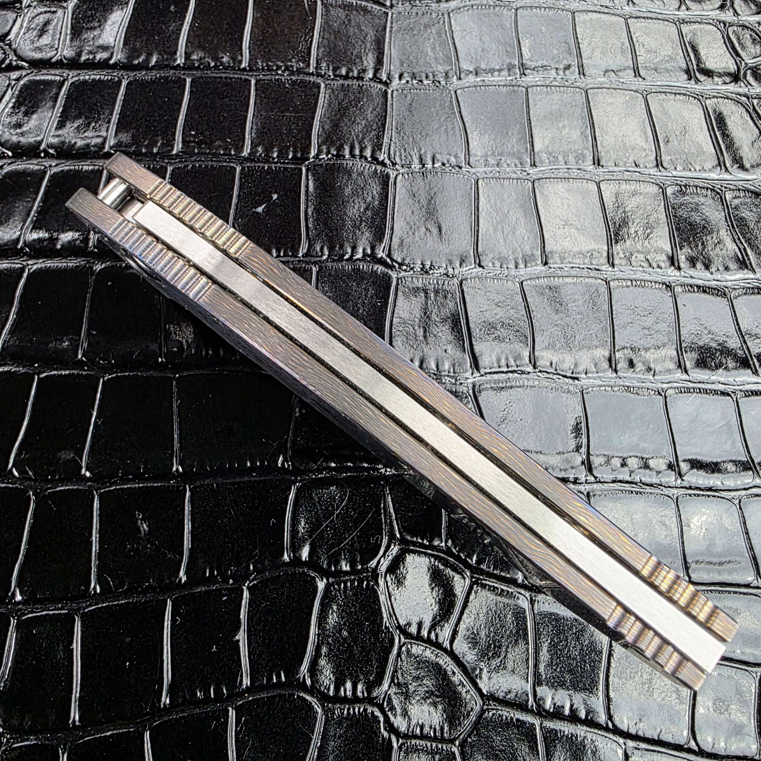 Spine view of the closed Reese Weiland Hawkbill 2nd Gen showing the milled frame edges