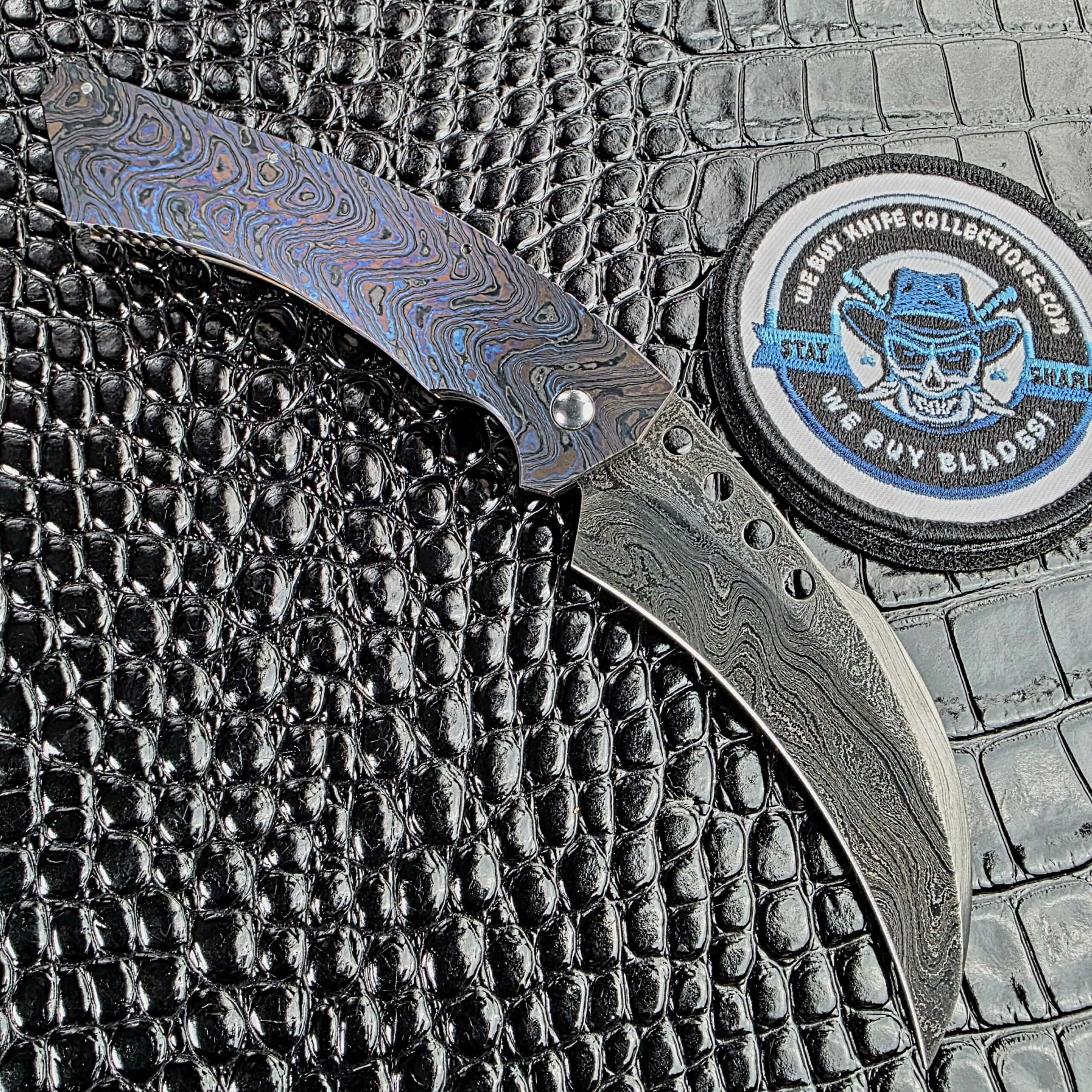 Reese Weiland Hawkbill 2nd Gen open on the button side, showing the recessed firing button in the Timascus frame