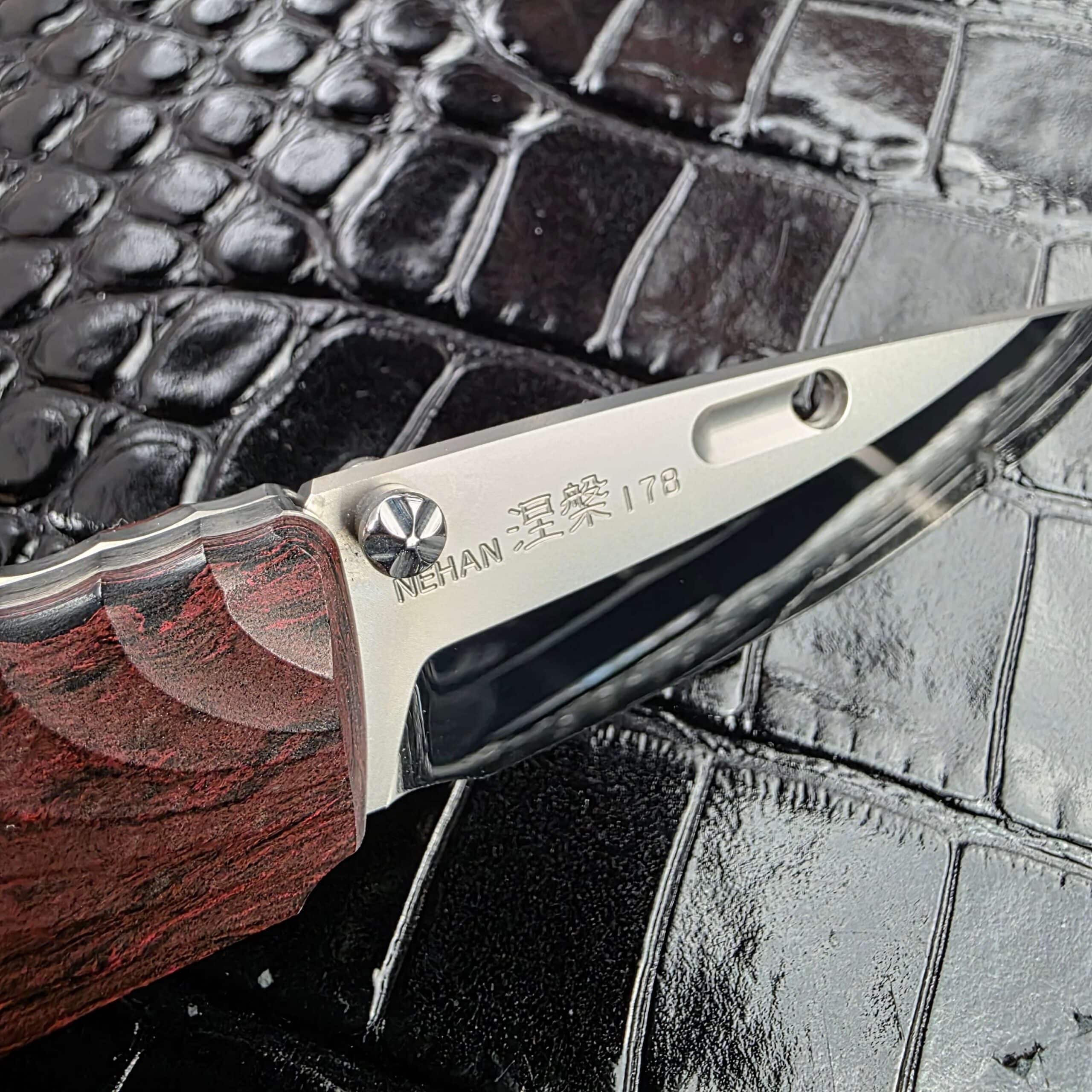 NEHAN kanji and serial 178 etched into the ZDP-189 blade of the Rockstead NEHAN