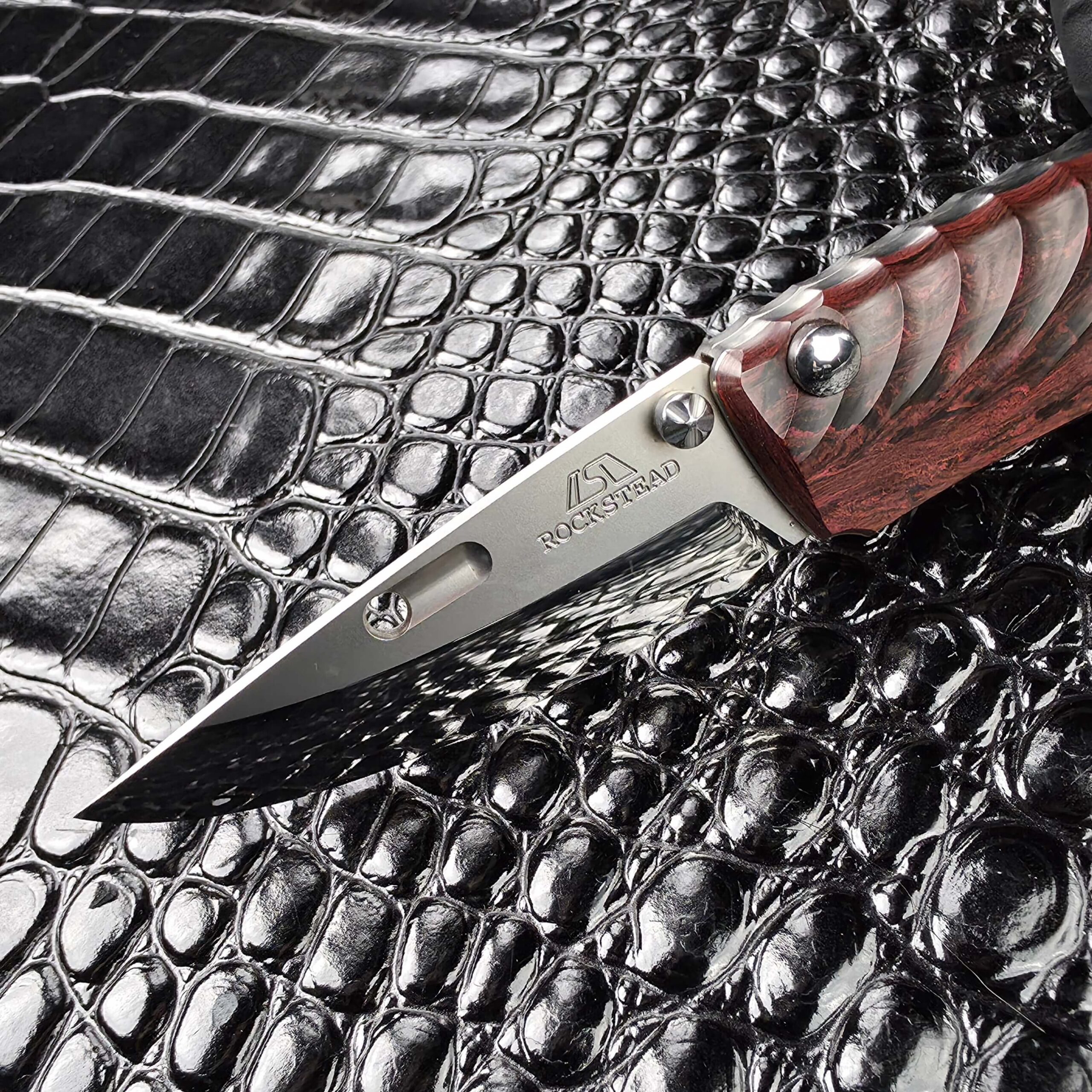 Rockstead maker mark and wordmark etched on the ZDP-189 blade of the NEHAN