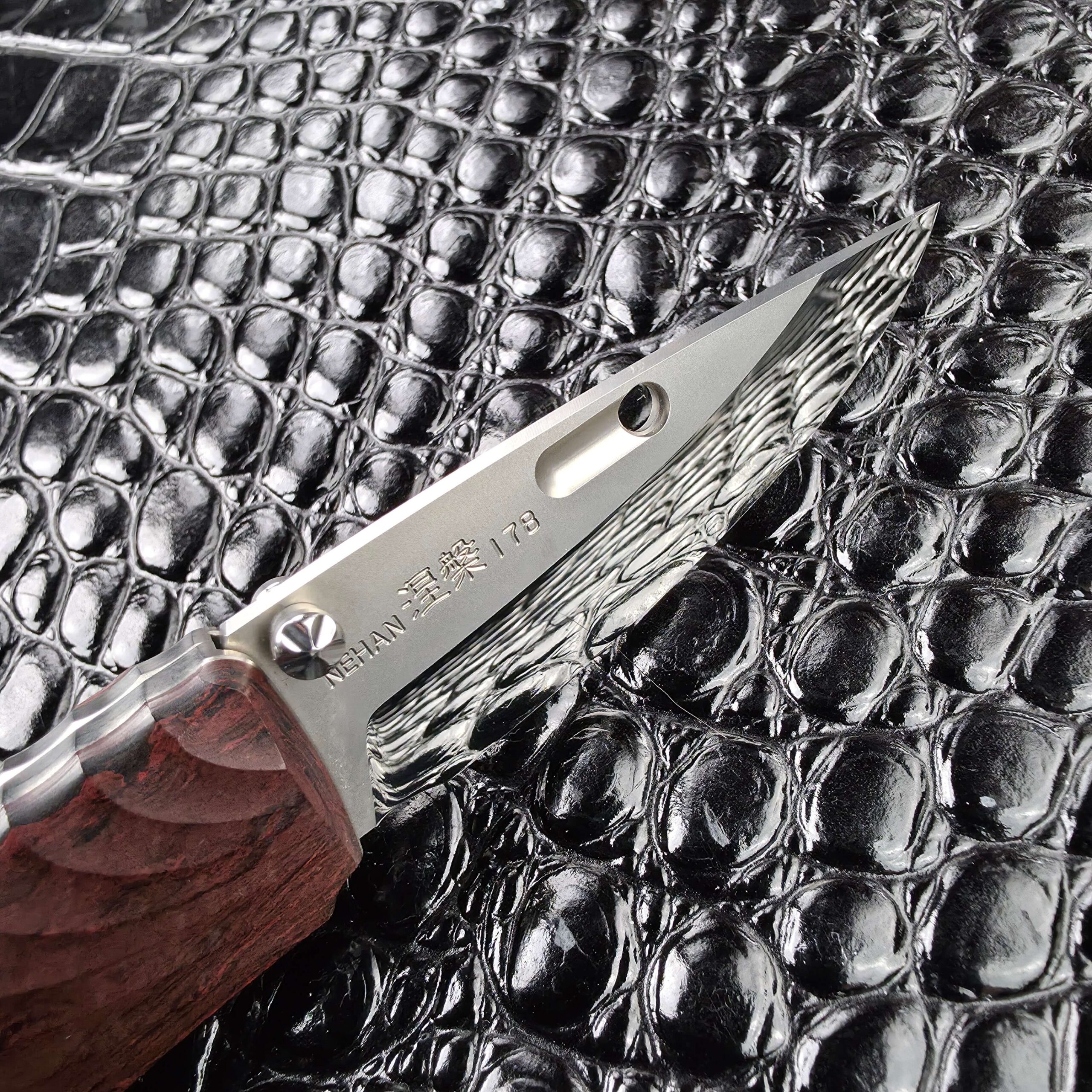 Rockstead NEHAN open on the opposite face showing the NEHAN kanji and serial 178 etched on the ZDP-189 blade